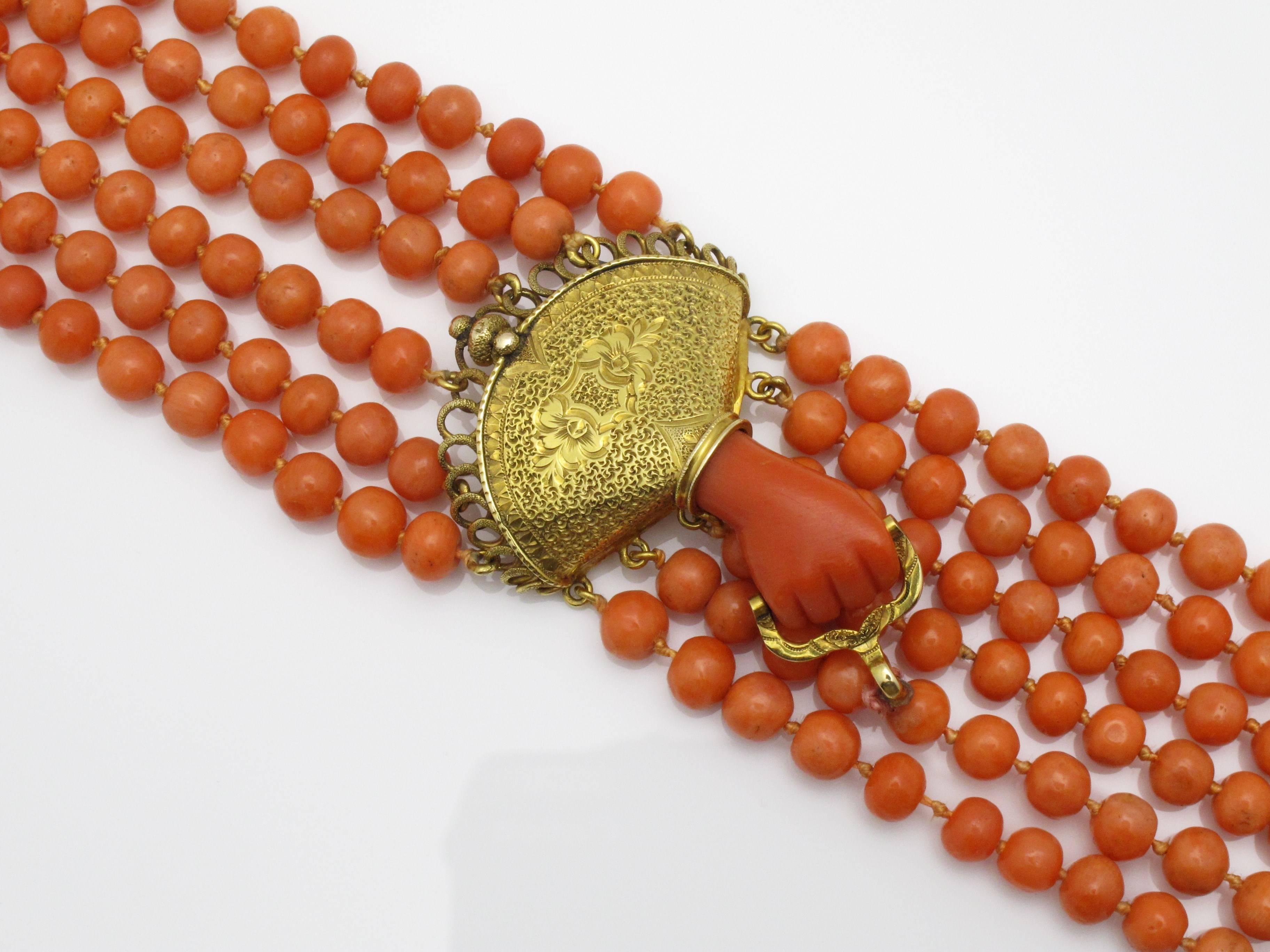 Beautiful Victorian English etched gold and coral bead bracelet with hand grasp motif, c.1870.