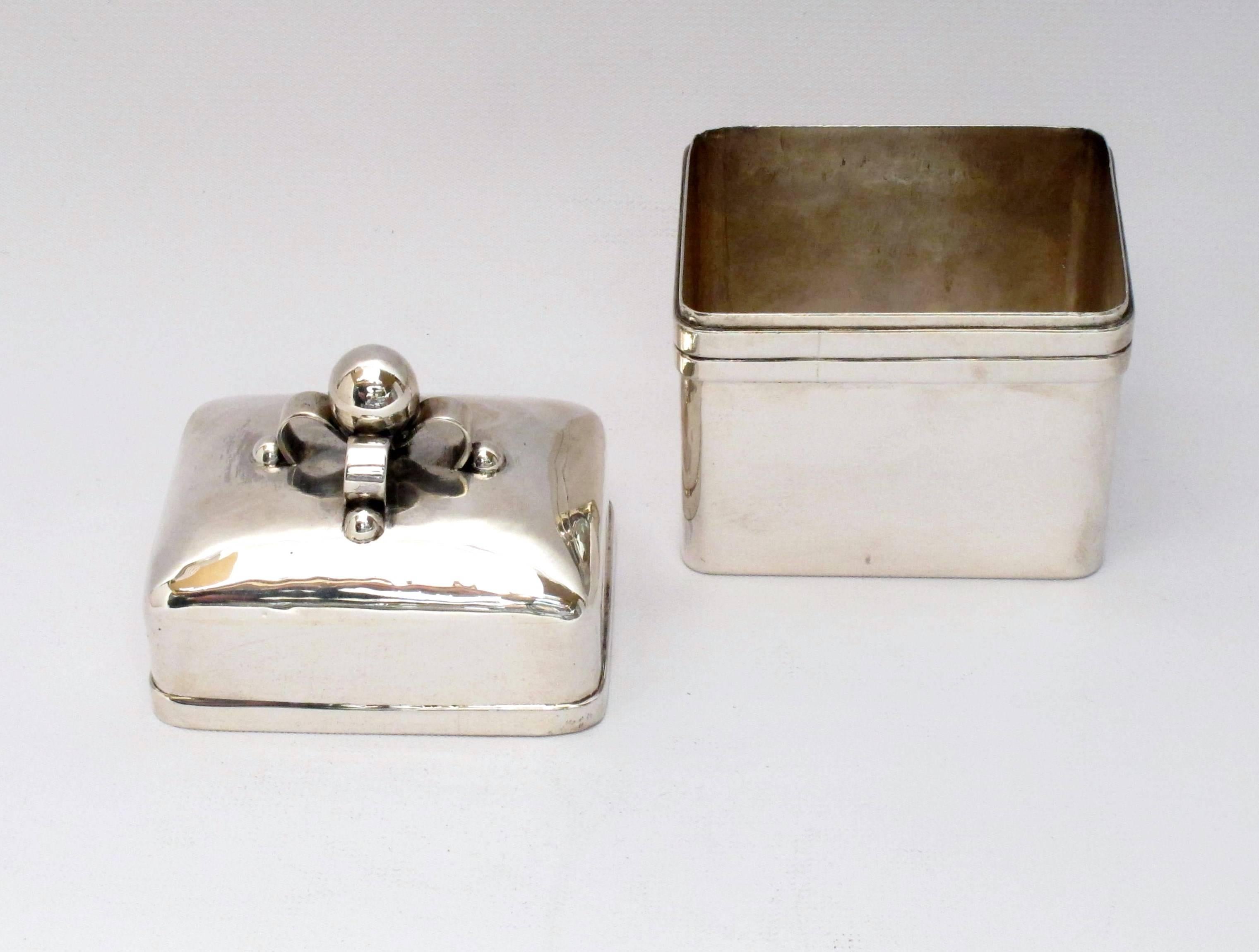 Beautiful sterling silver tea caddy by William Spratling with ribbon style finial.