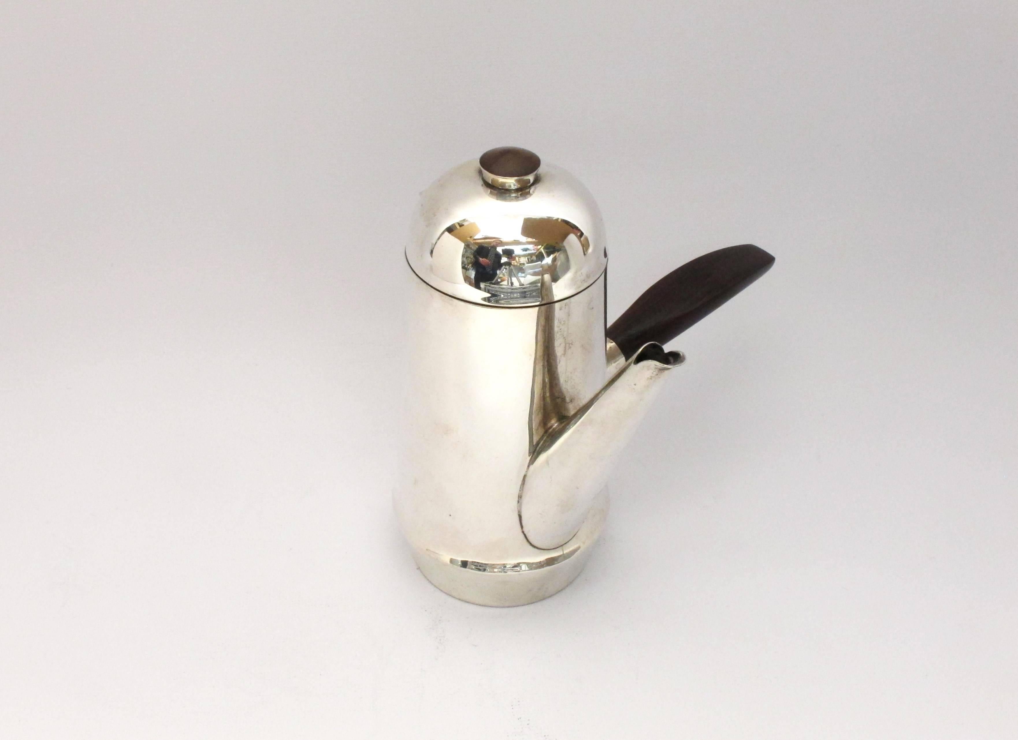 Stunning art deco sterling silver espresso pot by WIlliam Spratling 1964-1967. Handmade with rosewood handle and finial. 

7