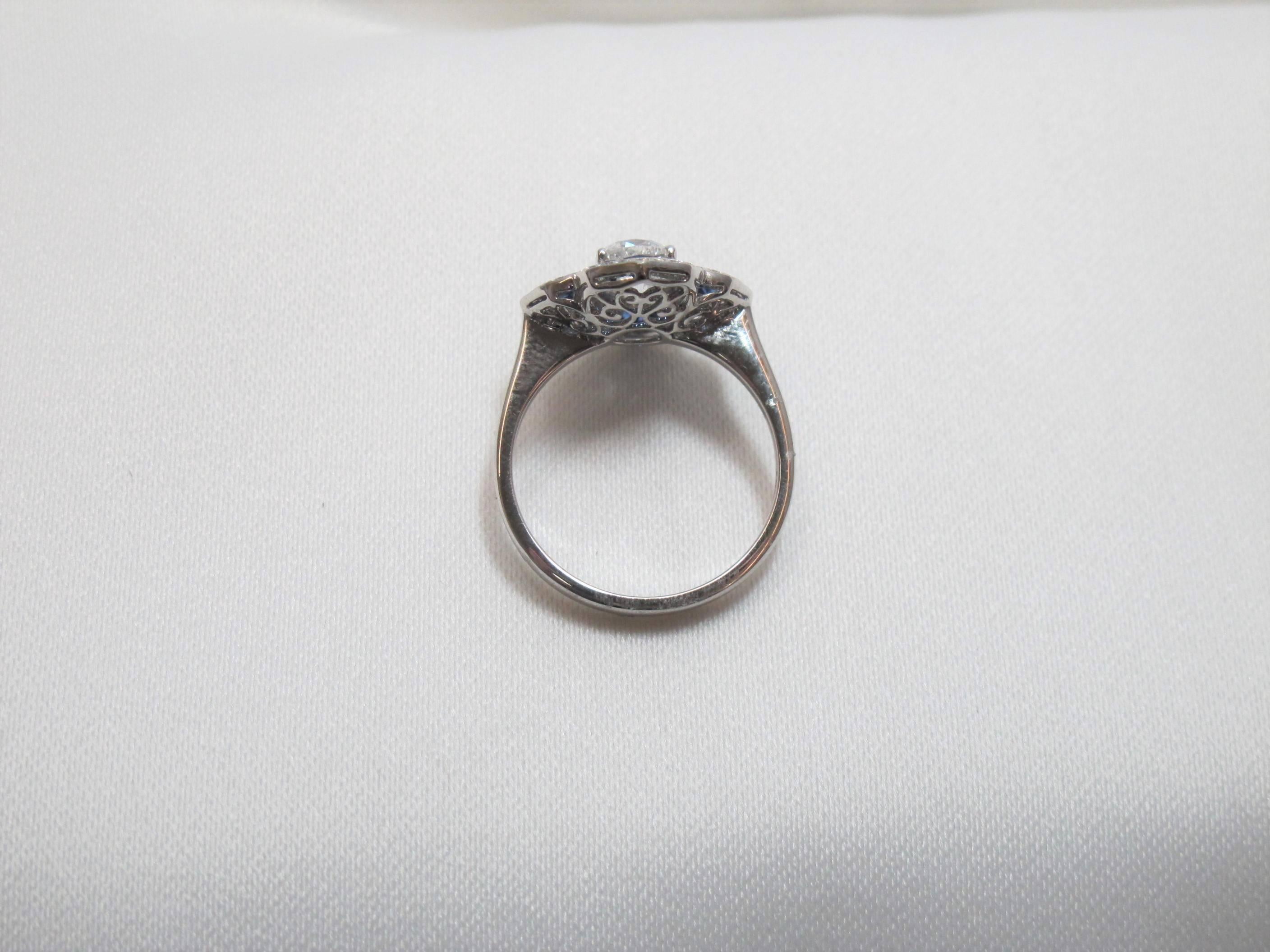 Platinum mounted .92 carats Cushion Cut Diamond ring with .32 carats Sapphires. EGL Certified diamond. Ring is a size 6.5