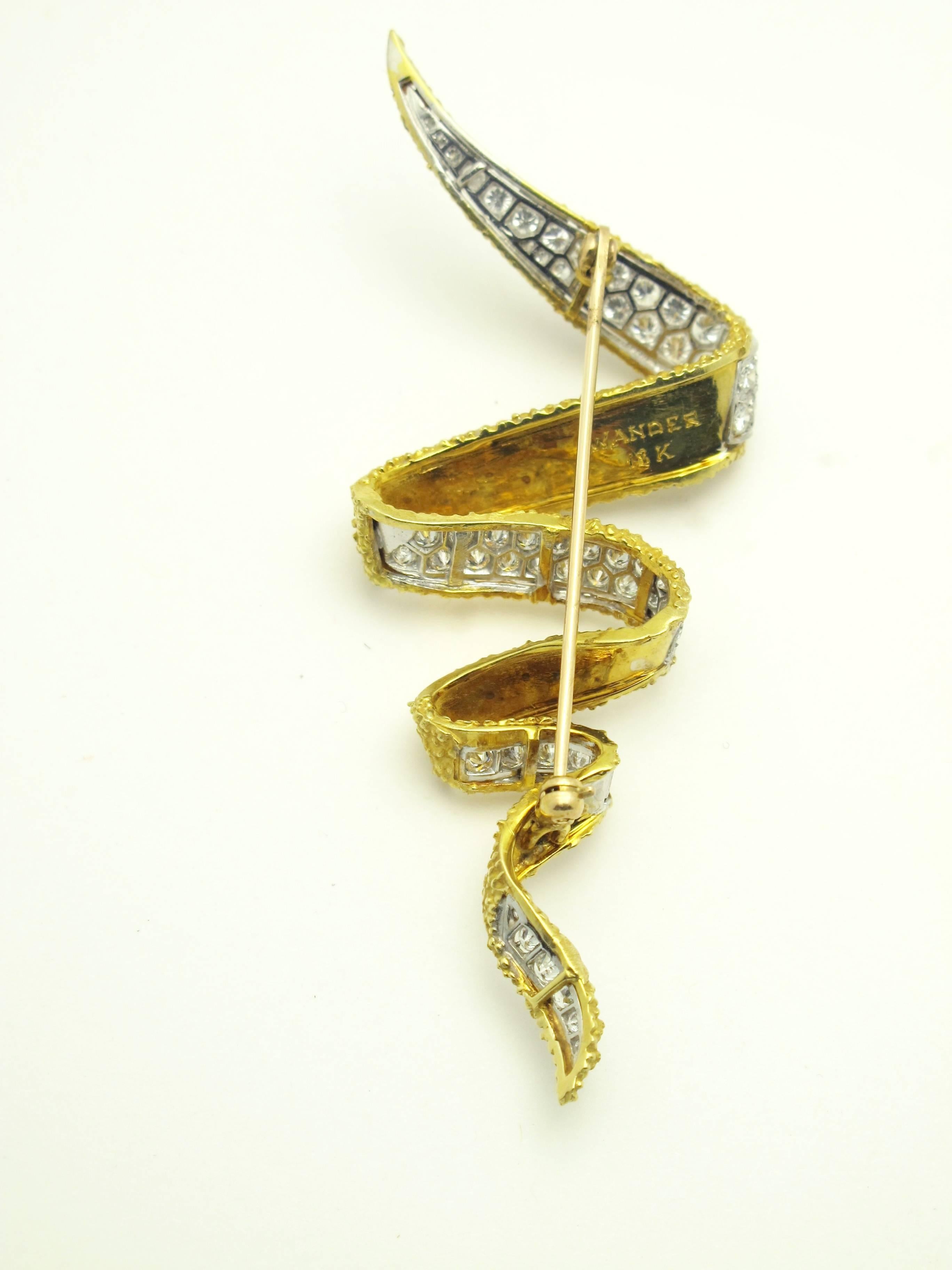 Wander gold and a diamond ribbon brooch set in 18kt white and yellow gold with 4 carats of diamonds average color G/H clarity VS.