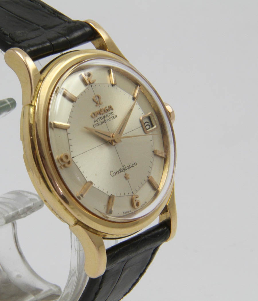 Constellation
Ref. 14393
Nice classical watch.

Case-Screwed case, pink-gold, acrylic glass

Movement-Caliber Omega 561, 24 jewels, 5 adjust., automatic, chronometer, date

Dial-Original 18ct.gold dial

Bracelet-Leather strap,