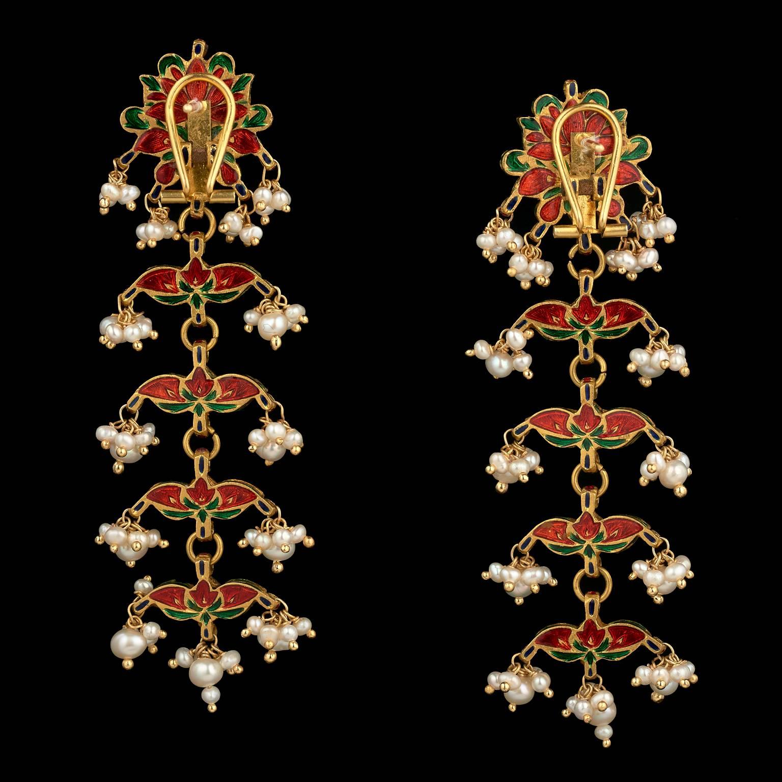 A pair of earrings made in Rajasthan, India (probably Jaipur) in the 19th century. Fabricated from gold and set in kundan (traditional pure gold setting) technique with diamonds, strung with natural pearls. The reverse is enamelled in red on gold.