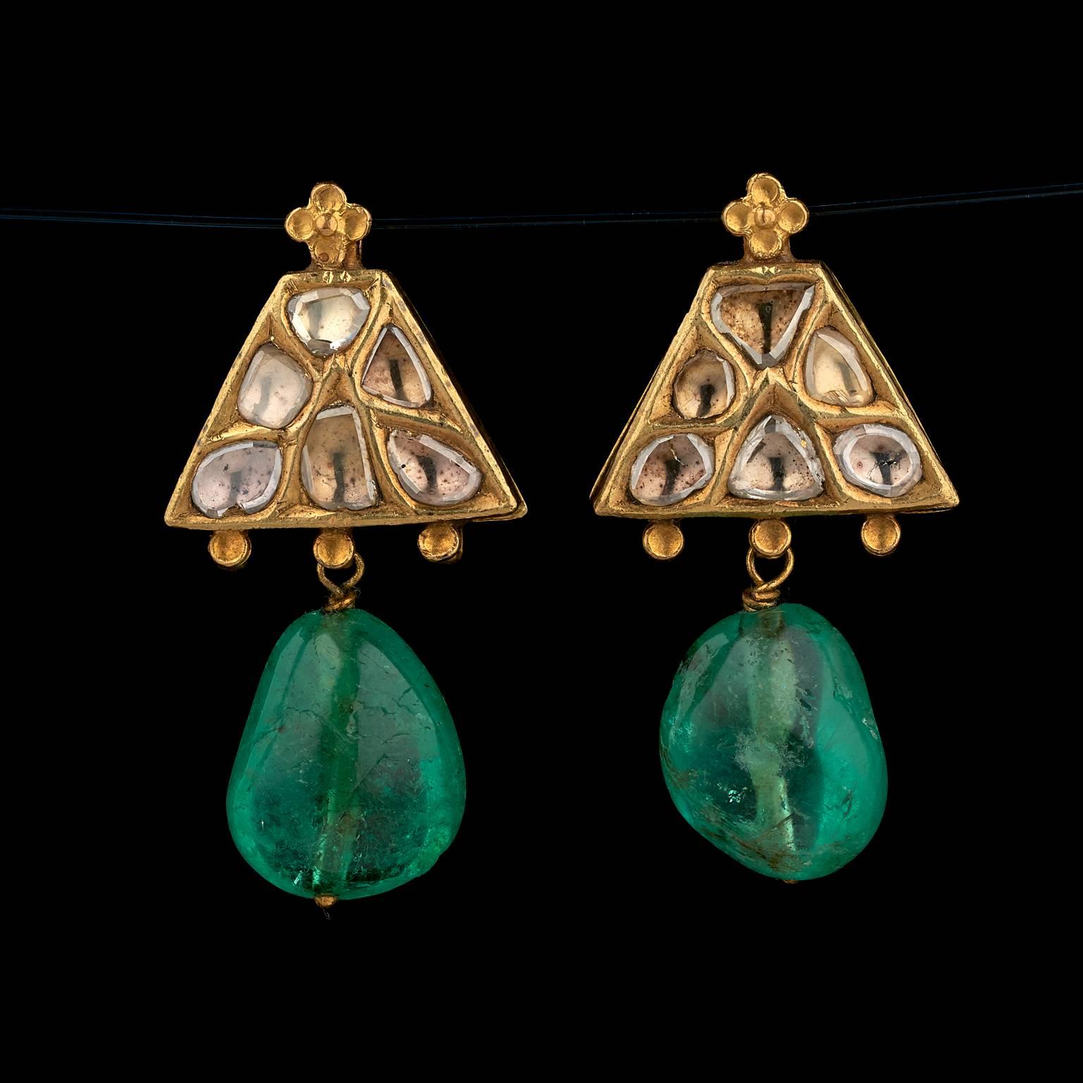 A Pair of Earrings
Mughal or Deccan, India
18th Century

Fabricated from gold, the front worked in kundan (traditional pure gold setting) technique, set with table-cut foiled diamonds. The back is textured, chased and engraved in relief with