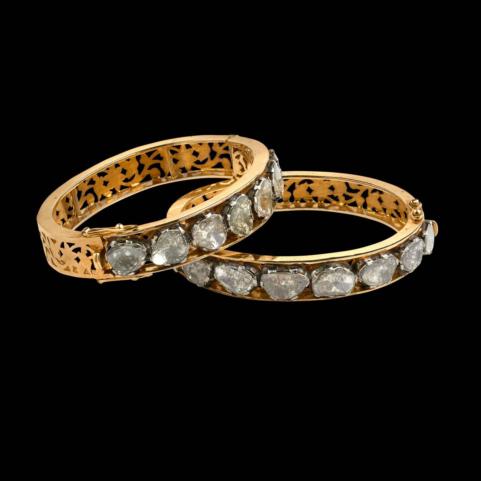 A Pair of Bracelets
North India
Modern

Fabricated from silver and gold, set with old style table-cut diamonds in silver foil on the front. The back and interior of the bracelets embellished with cut-work design.
