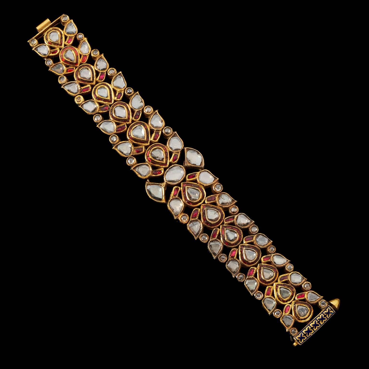 Bracelet
Jaipur, North India
20th Century

Fabricated from gold, set with champagne hued diamonds and rubies in a floral and foliate design. The reverse is enamelled.
