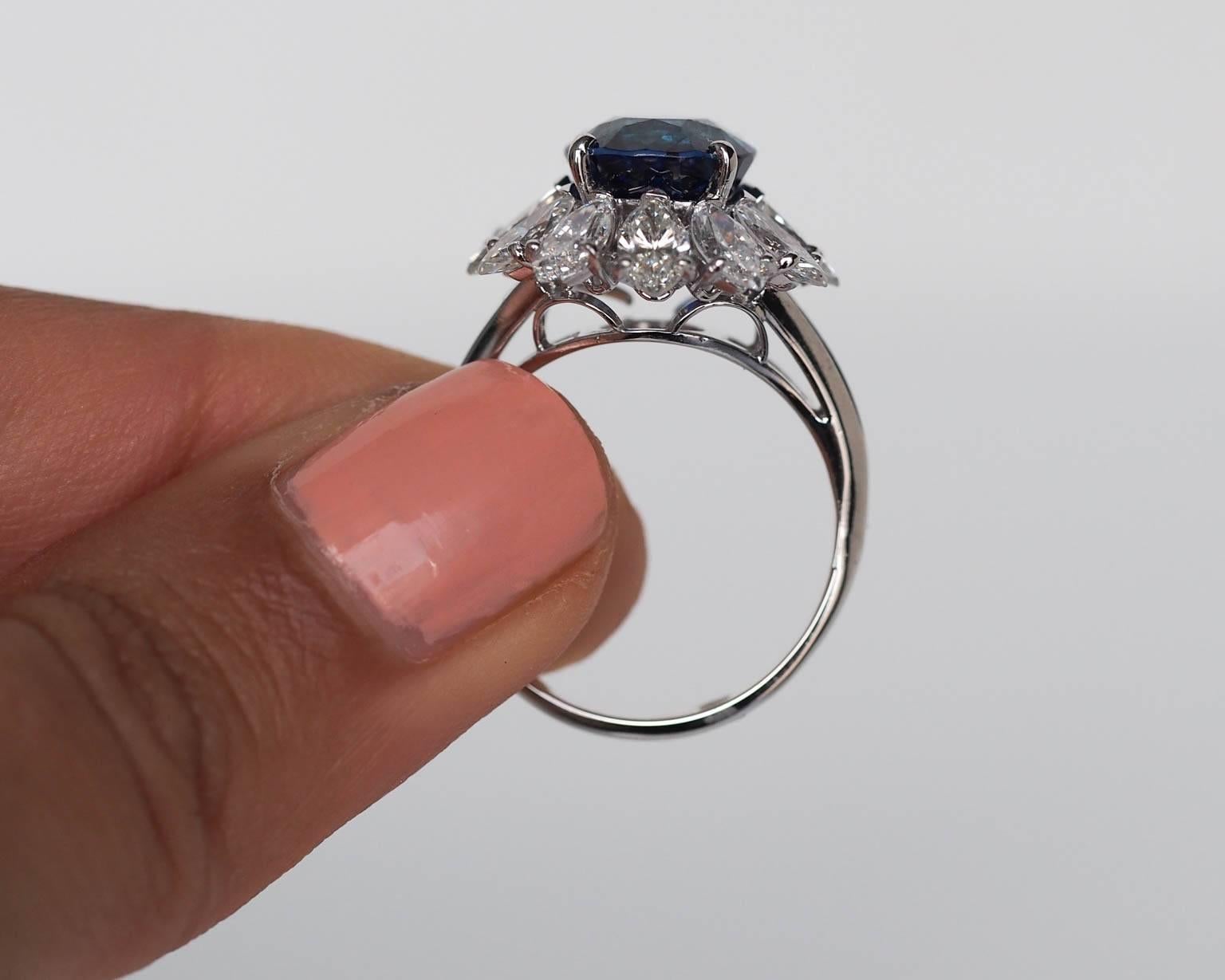 This is an incredibly rare & spectacular piece. This hand made platinum ring features 4 carats of F color VS clarity matching marquise cut diamonds as a halo around the center stone. These high quality diamonds create a 