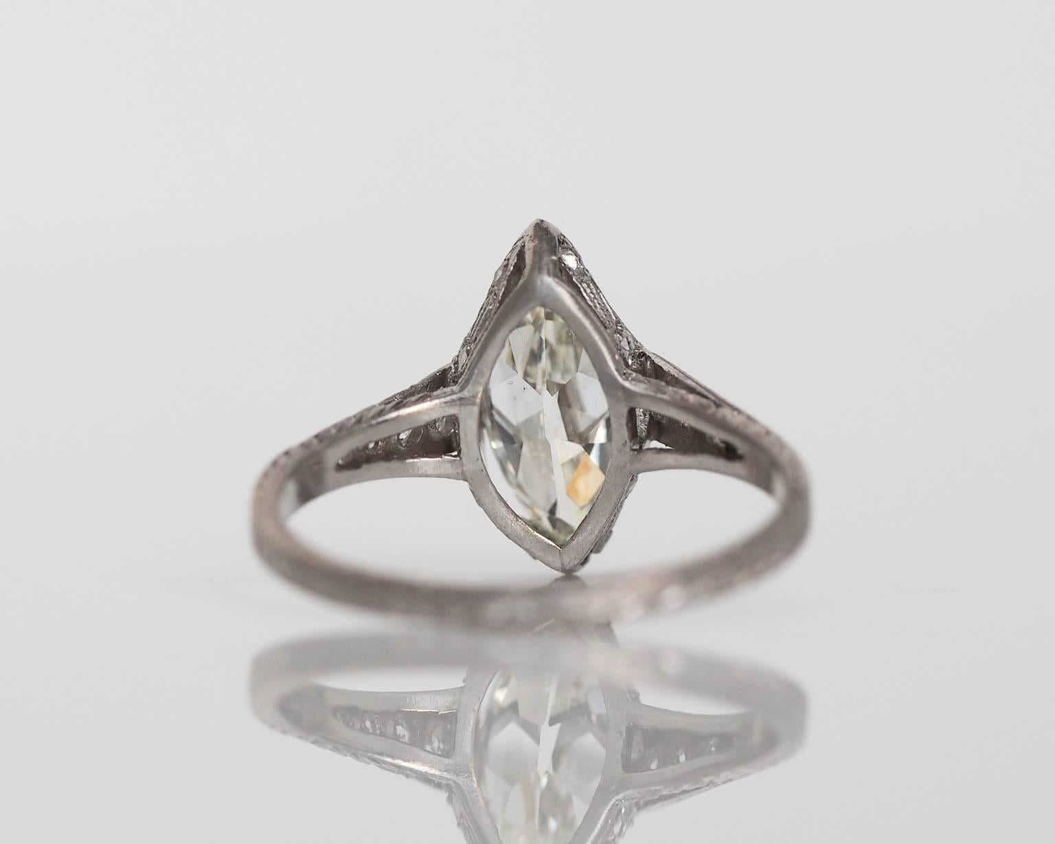 1910s Edwardian GIA Certified 1.55 Carat Diamond Platinum Engagement Ring. The center stone is a GIA certified 1.55 carat Antique marquise with an ultra clean VS2 clarity, and white facing J color. The stone is super long and has very good polish