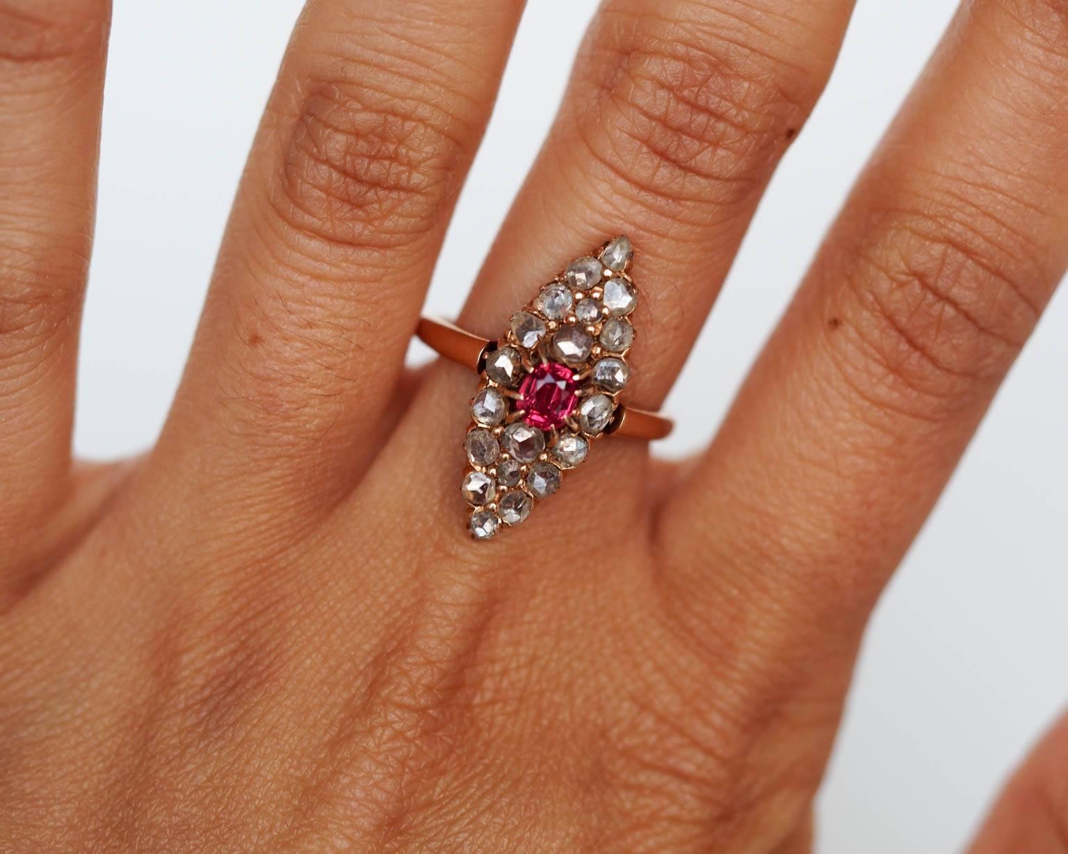 Here is a beautiful piece, with an amazing look. The center stone is a .40ct natural pink sapphire that has one of the most beautiful colors we have ever seen in a pink sapphire! It is surrounded by well cut antique rose cut diamonds weighing a