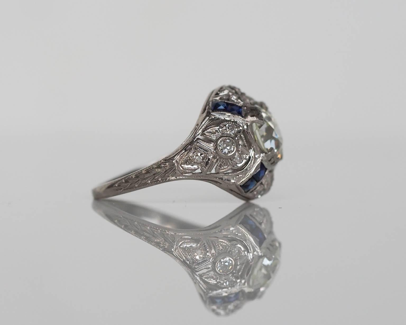 Here is a spectacular art deco engagement ring, with ultra high quality components. The piece is hand crafted in platinum with very intricate and precise set diamonds around the head. The center diamond is a large 1.67ct GIA certified Old European