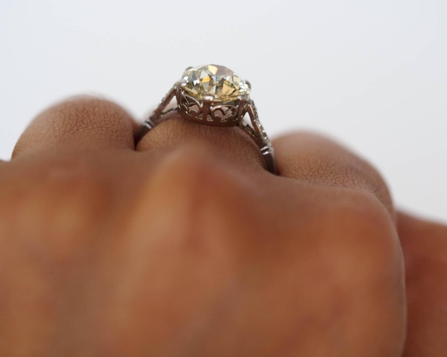 

Here is an absolutely jaw dropping & delicious engagement ring. This platinum Edwardian piece is hand crafted in platinum, with beautiful gallery work under the basket of the ring and antique cut diamonds on both sides of the center stone. The