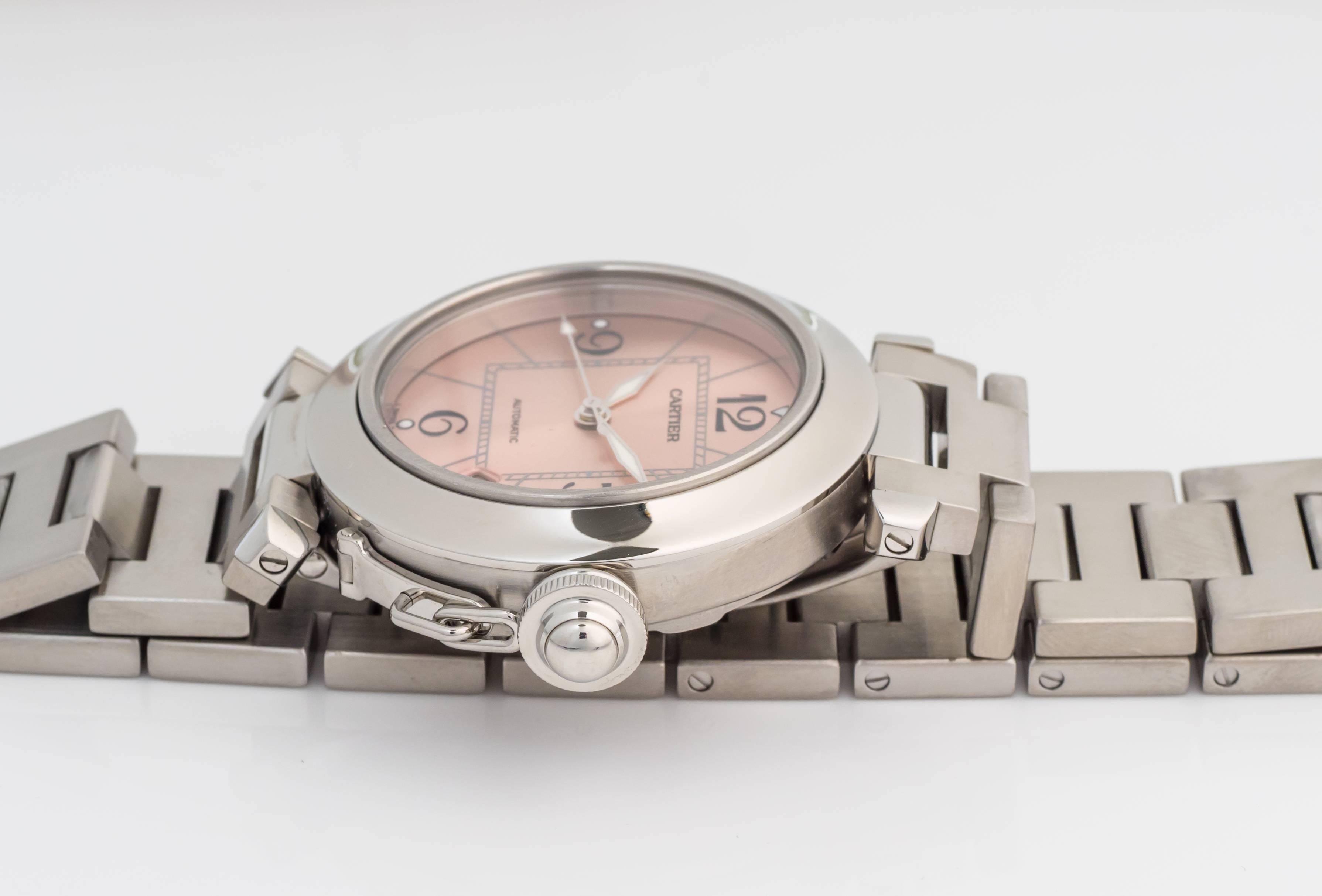 Featured here is a Cartier Pasha in pristine condition. Freshly polished, it features a brushed steel 35mm case. There are 8 screws in case back and watch has been recently serviced and tested to be water-resistant. It features a gorgeous salmon