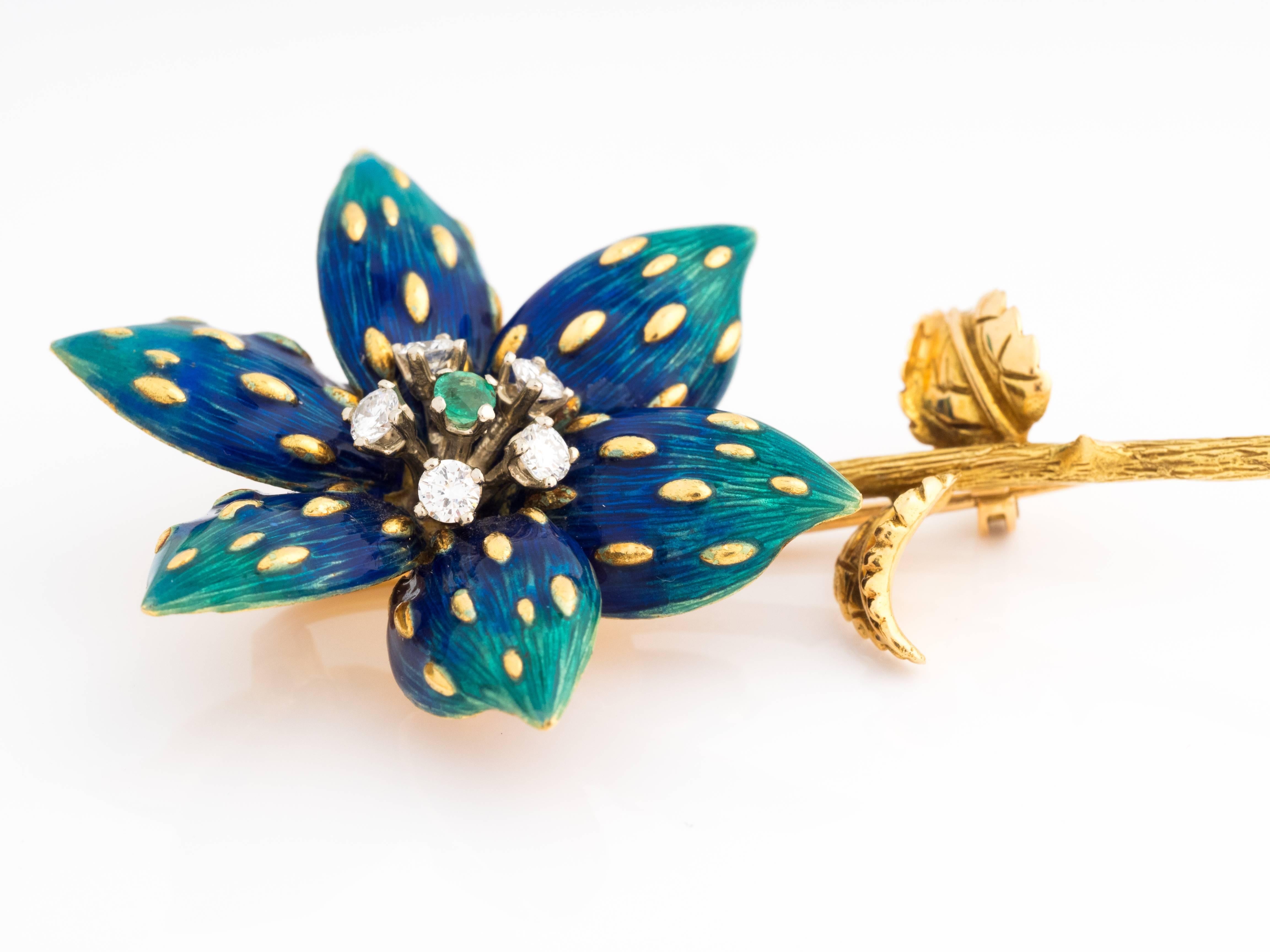 Exquisite hand-made floral pin/brooch ft. intricate enamel work reflecting deep blue hues to lighter green hues. The pin has raised yellow gold ridges throughout the petals in a uniform pattern. The center of the flower features five diamonds in a