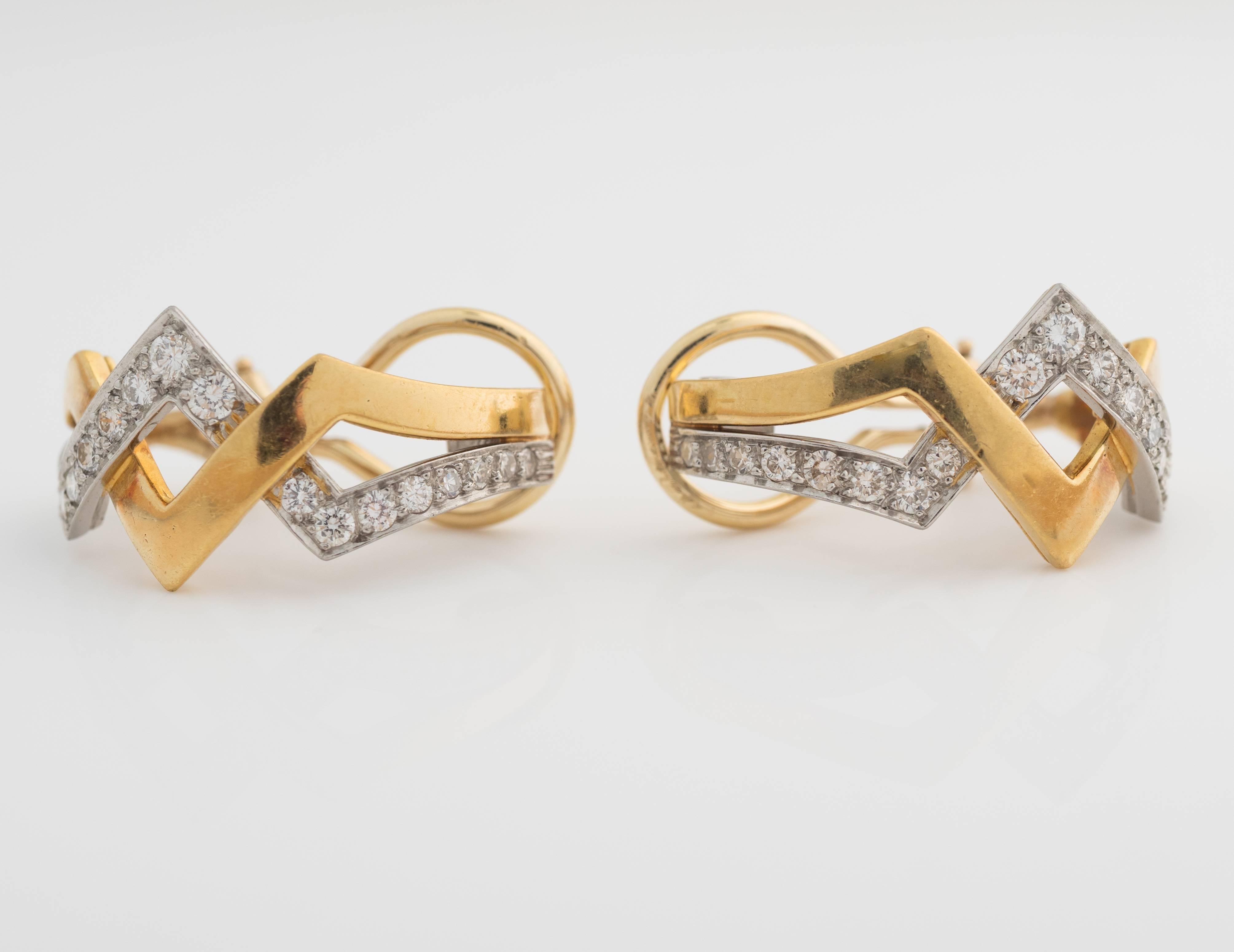 1960s Diamond Earrings crafted in 2-tone mixed metals, platinum and 18kt gold. These feature 1 carat total weight of diamonds boasting F color, VS clarity. The diamonds are set in platinum, intertwining in and out with 18kt yellow gold high polished