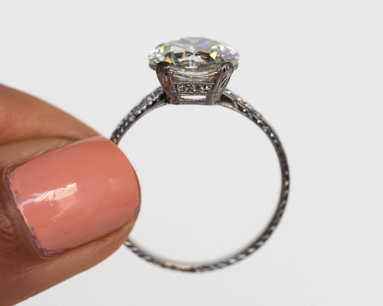 1910s Edwardian GIA 3.44 Carat Old European Diamond Platinum Engagement Ring. The center diamond is one of the absolutely most beautiful old european cut diamonds we have seen. The size is massive! The culet is large, something we LOVE in our old