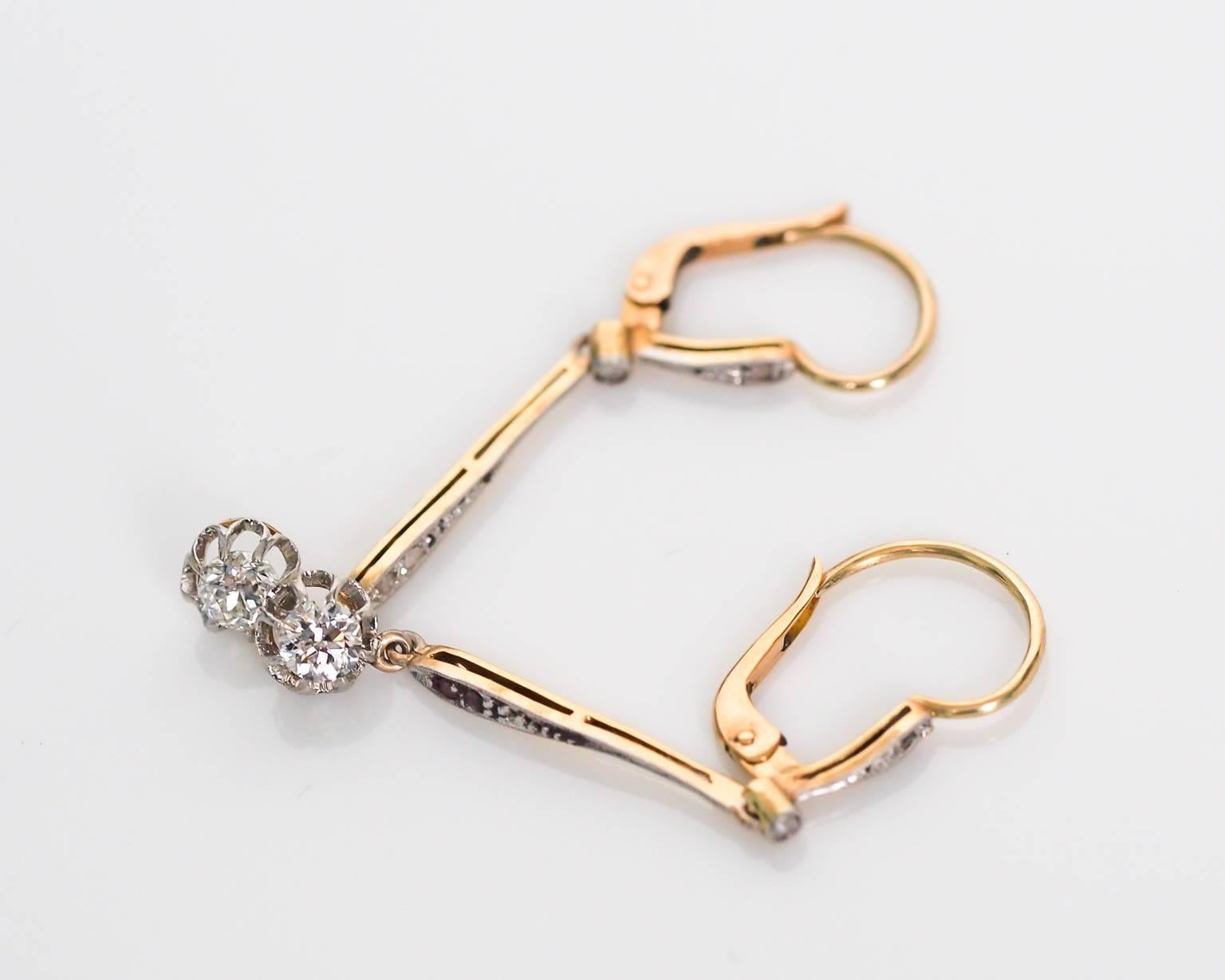 A beautiful pair of Victorian drop dangle earrings. The old mine cushions on both earrings weigh .27ct each and are set witha buttercup prong style. There are 2 rose cut diamonds on each earring as well. 

This piece is accompanied with a GIA