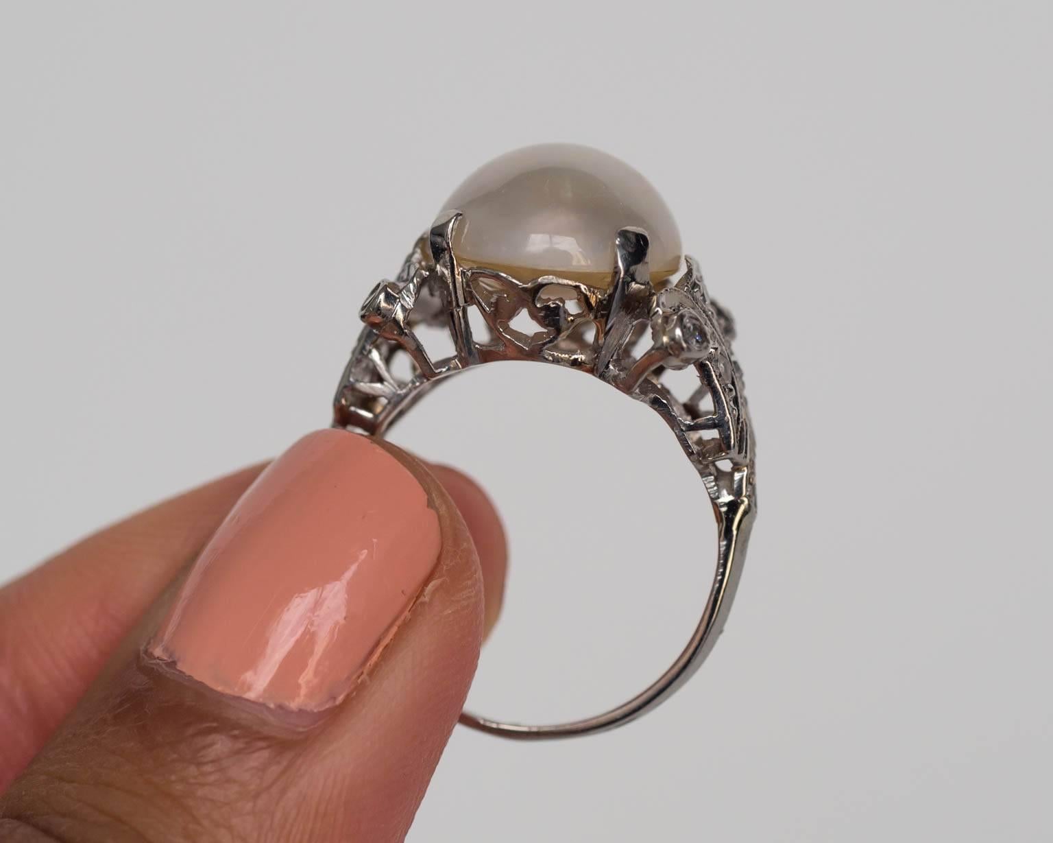 Here we have a gorgeous ring that exemplifies elegance and royalty! It is a spectacular pearl and diamond 14k white gold cocktail ring (and would also work well as an anniversary ring) from the 1930s. We absolutely adore the sparkly diamonds and the