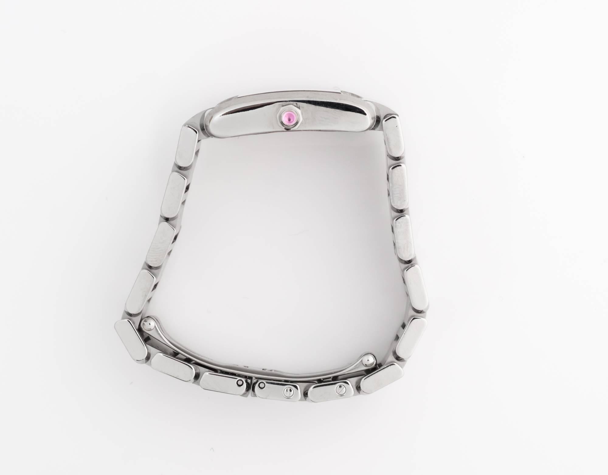 Stainless steel case and bracelet, Amazing Condition. Raspberry dial with steel-tone hands and Roman numeral hour markers. Quartz movement. Steel octagonal crown set with a pink sapphire cabochon. Scratch resistant sapphire crystal. Deployment