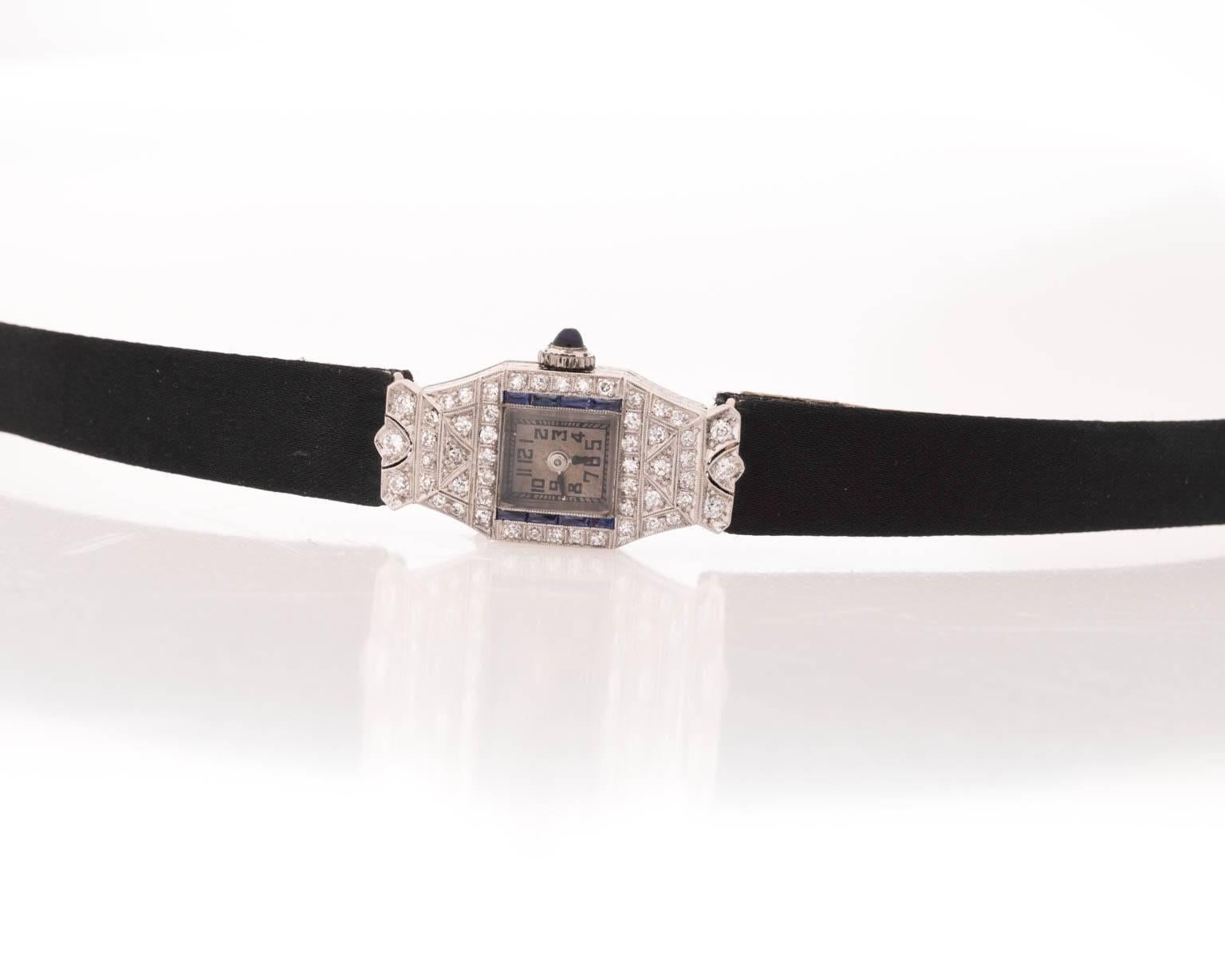 Ladies platinum art deco watch with sapphires and diamonds. Watch is on custom strap and buckle. Crown is natural sapphire. 