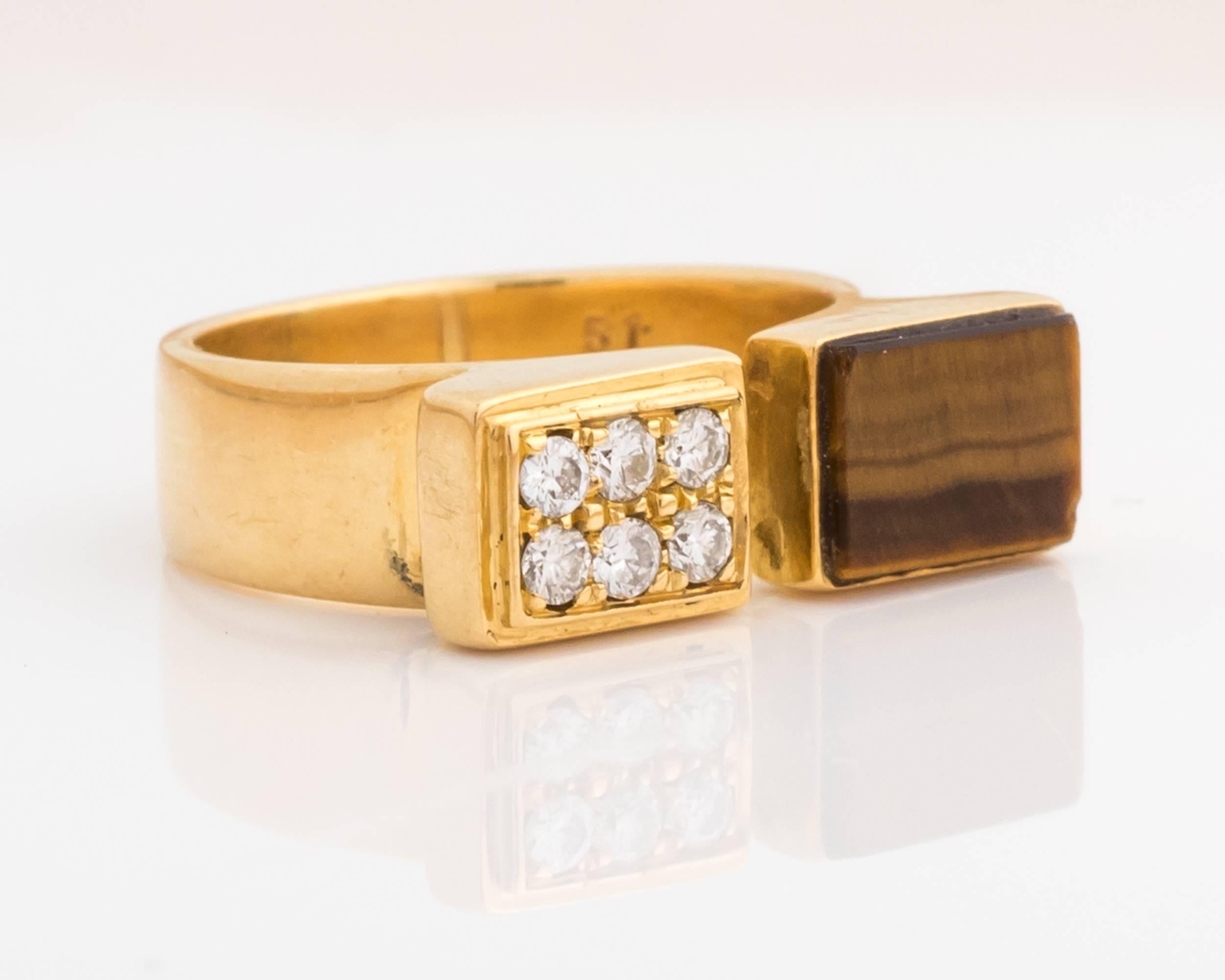 Classically retro Cartier ring, embodies retro style with colorful gold, a vivid tiger's eye stone, and sparkling diamonds. Features symmetrical cuts, giving the ring a distinctive look. Beautiful color play visible on the brown tiger's eye stone.