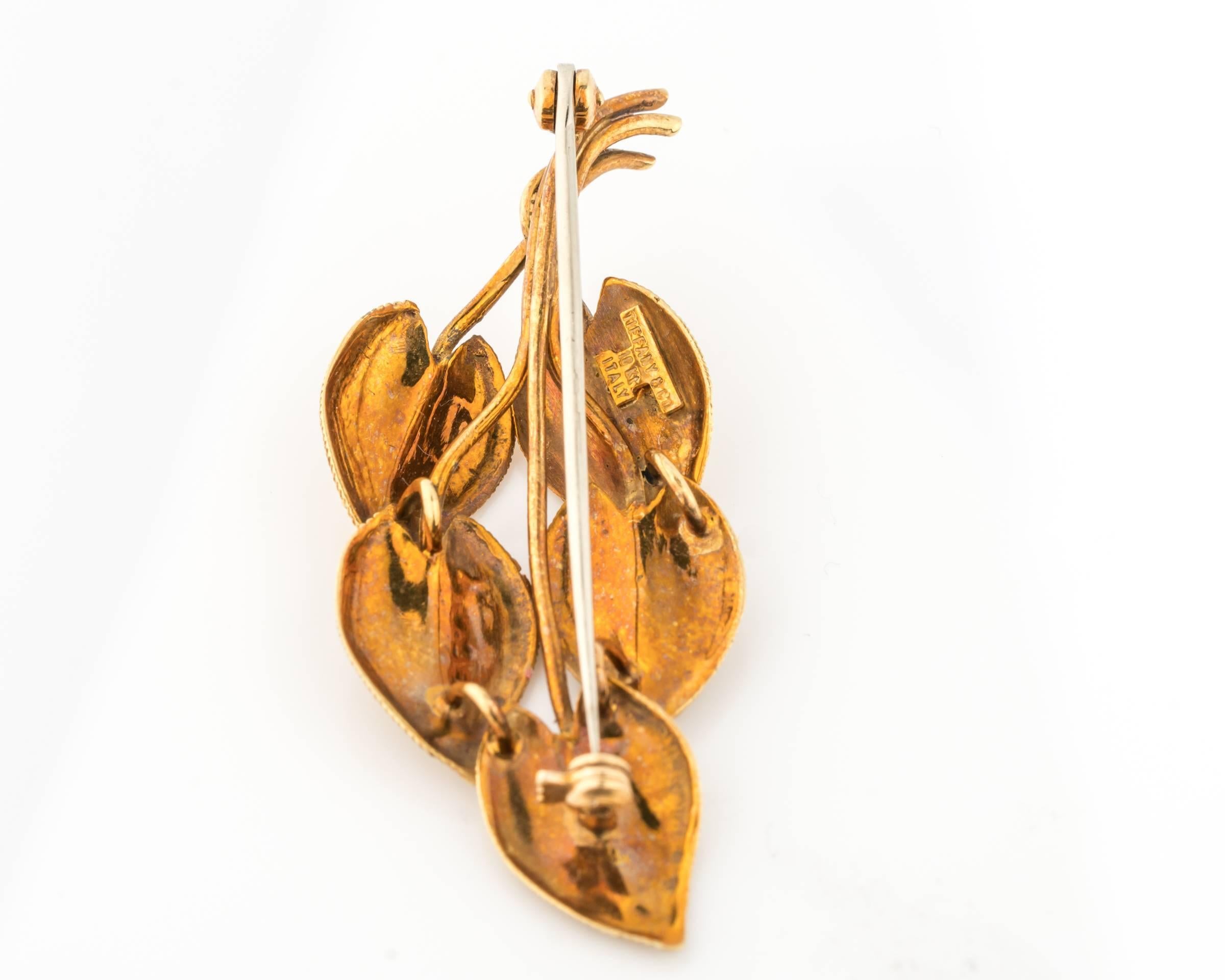 Circa 1960s classic Tiffany & Co. 18k gold pin with a nice natural patina that shows the time sure has passed since original purchase. Features 5 leafs with horizontal raised striations going across and one solid vertical gold line in the center of