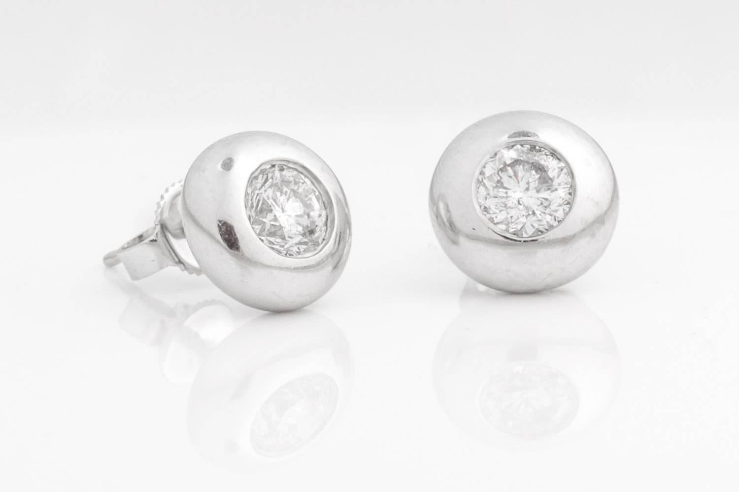 Classic style with a slight modern twist, these earrings embody a sophisticated retro-inspired style with large beaming diamonds as the center piece to a great look! The diamonds are .50 carat each making the total weight for these earrings at 1