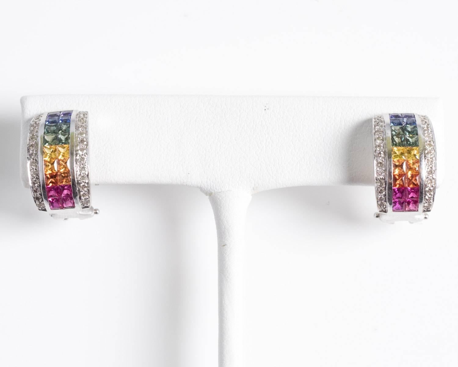 Fine quality vintage earrings from 1990s with beautiful color play to add the perfect statement to any outfit. Features various sapphires, both radiant and vibrant for any occasion. Princess cut sapphires in red, orange, yellow, green, blue and
