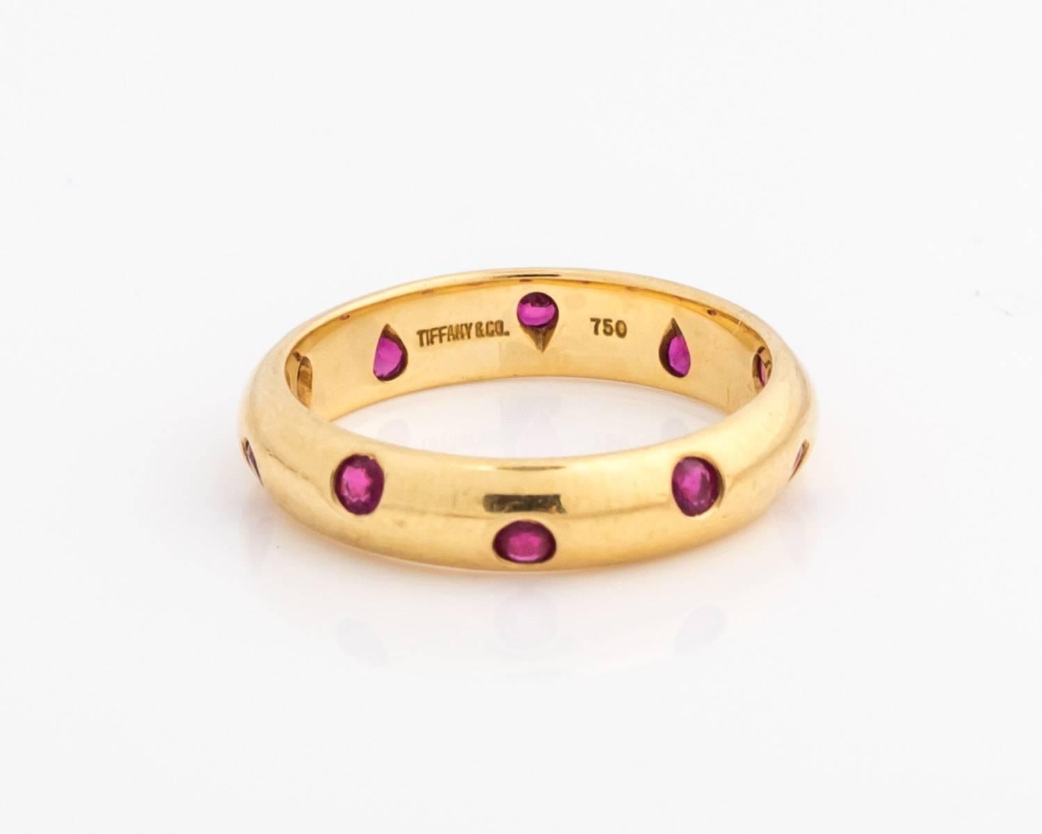 1980s Etoile Tiffany ring band in great condition! This piece is no longer sold on the website. The red rubies make it a unique ring full of color. The rubies and 18 karat yellow gold pair well to give this ring stunning character and charm. A total