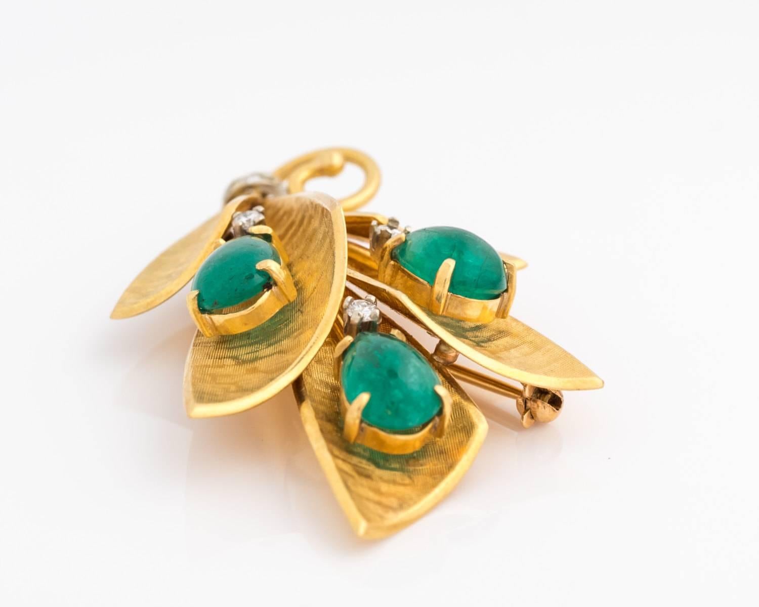 This authentic jade brooch has a gorgeous design wearable for any occasion! The 18 karat yellow gold has a satin finish on the front, and shiny polished finish on the back. There are three pear-cut jade accents which shine brightly with their vivid