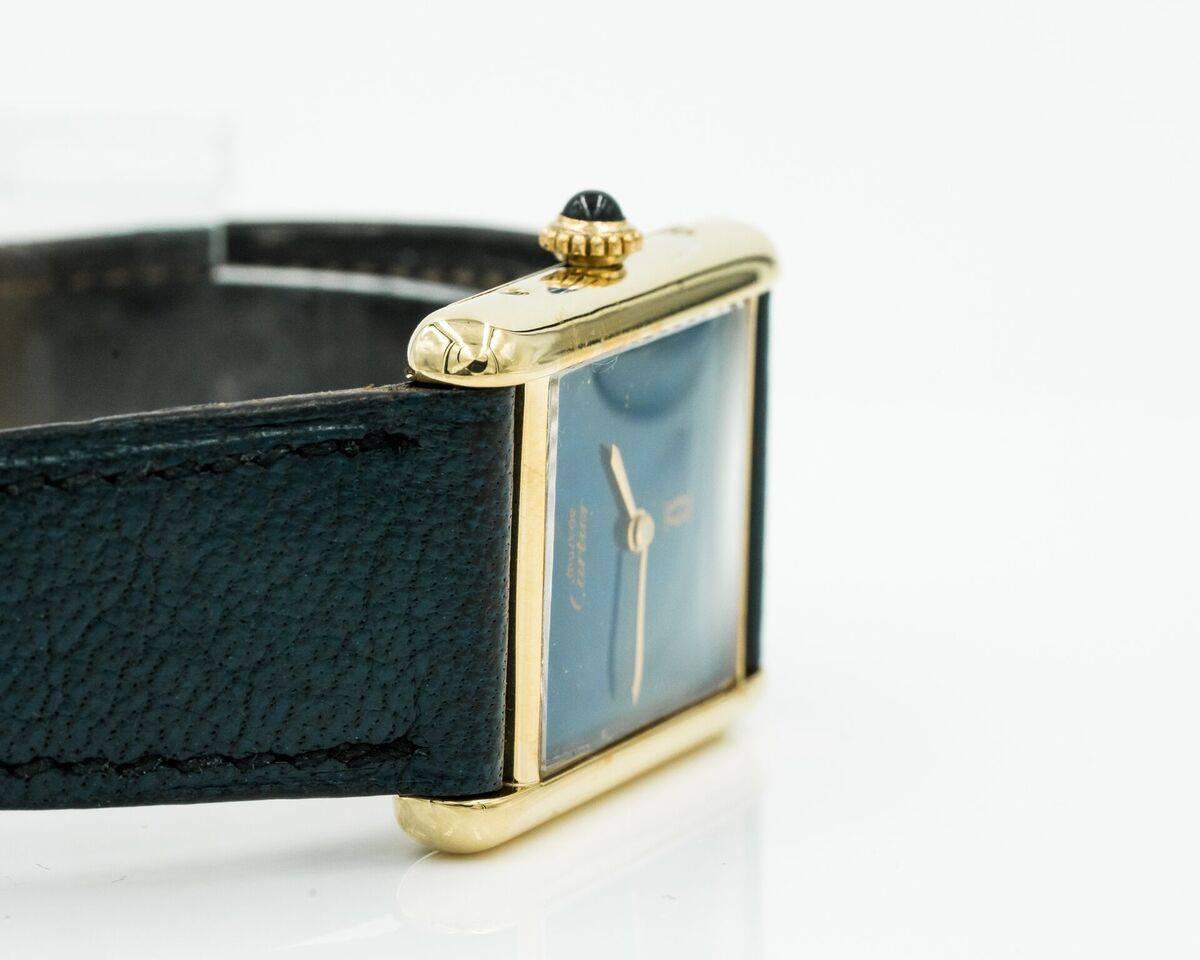 Stunning 1960s Cartier Tank Watch with Lapis Lazulli Dial. 
Sapphire Crown, Sterling Silver & 18 karat Gold Plate. Comes with original strap; worn condition but with lots of life left on it. Comes with original Cartier buckle.
Winding mechanism,