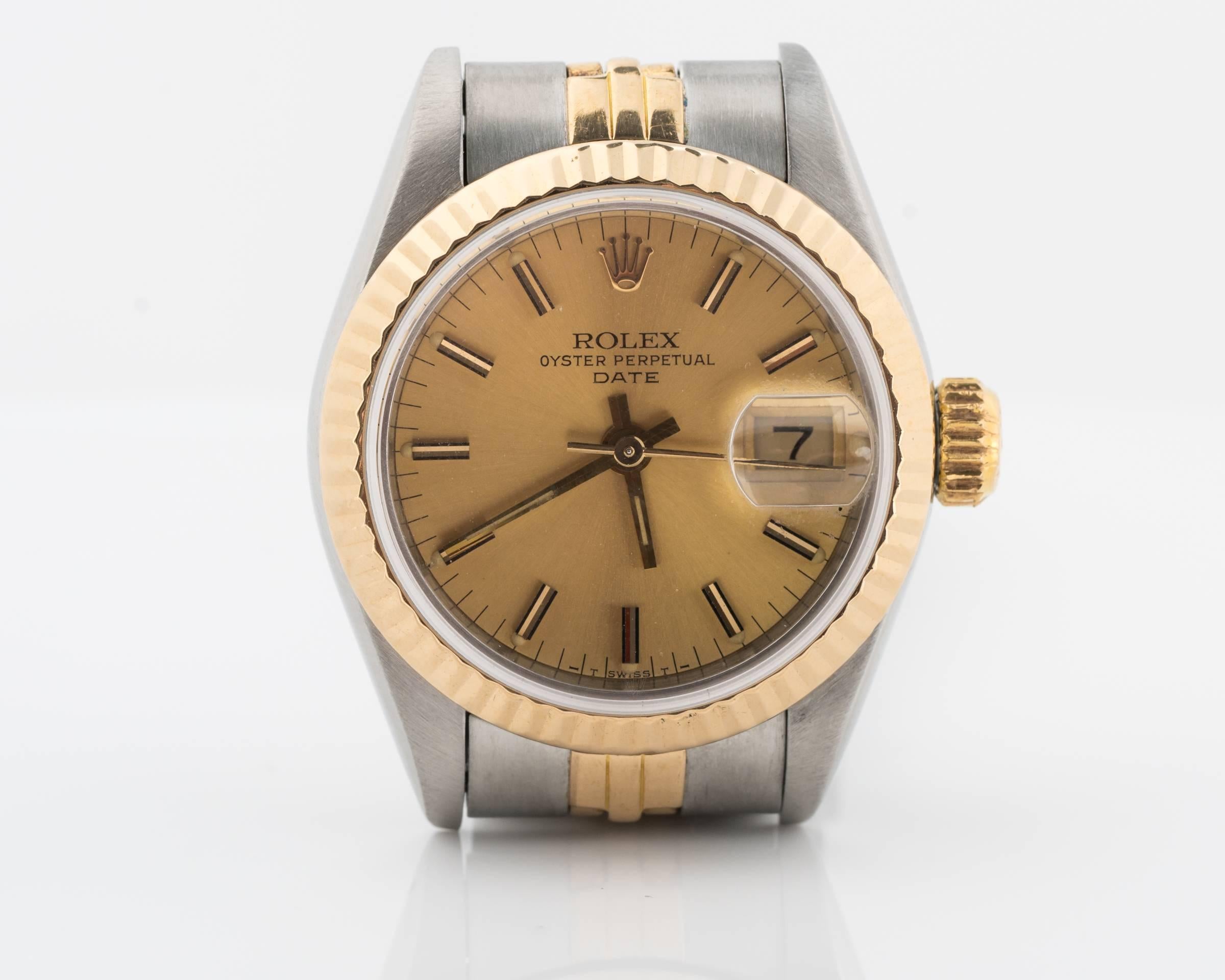 Vintage Ladies Rolex Date from 1984 
Two Tone - Stainless Steel and 18 Karat Gold with Jubilee Bracelet 
Champagne Stick Dial 
Sapphire Crystal  
Fits up to 7 inches 
26mm Case 
Reference # 69173, Accompanied with a Rolex box