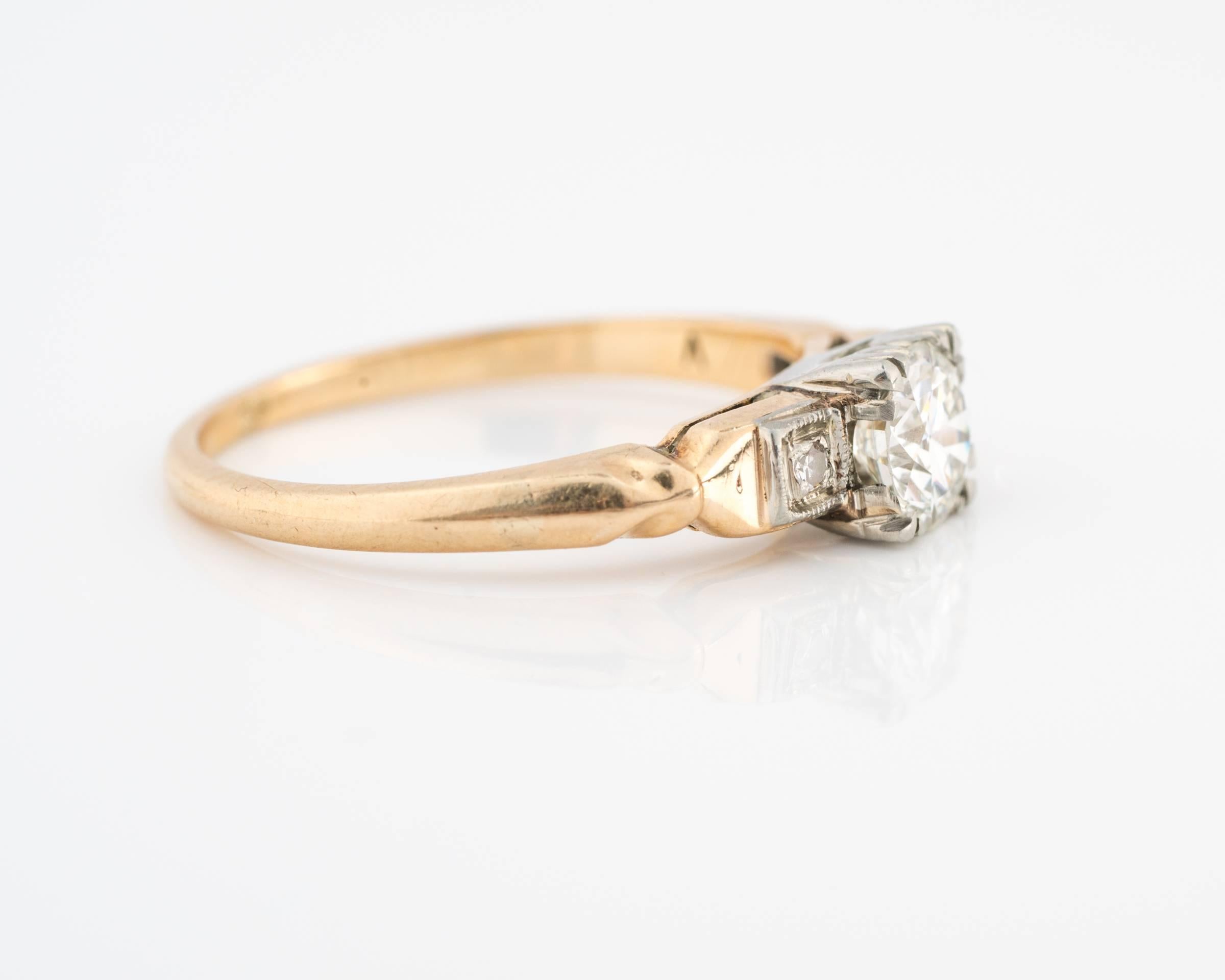 Beautiful mid 1920s Diamond Engagement Ring featuring a 0.42 carat center diamond, H color, VVS2 clarity. This diamond is GIA certified. The ring is made of two-tone metal: 14 karat white gold top and 18 karat yellow gold shank. The shank has a