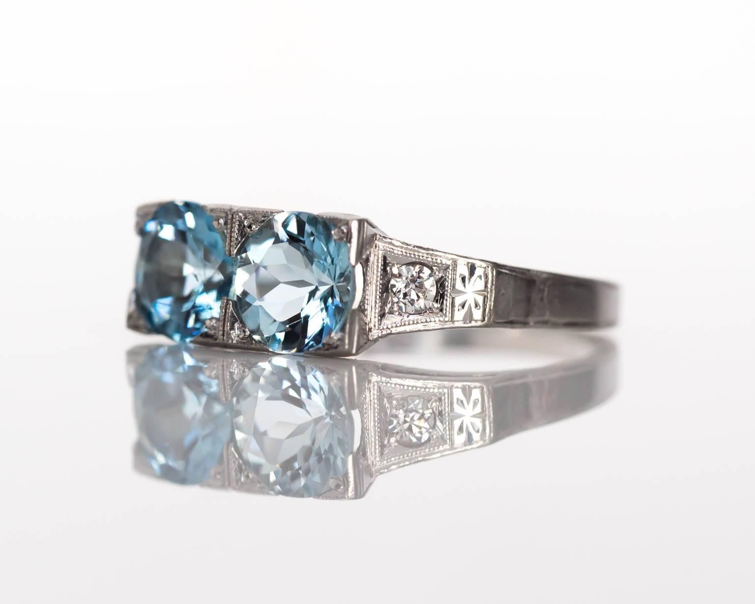 Item Details: 
Ring Size: 6.75
Metal Type: Platinum
Weight: 5.4 grams

Color Stone Details: 
Type: 2 London Blue Topaz
Shape: Round
Carat Weigh: 2.25 cttw
Color: Light Blue

Side Stone Details: 
Shape: Antique Round Cut
Total Carat Weight: .08