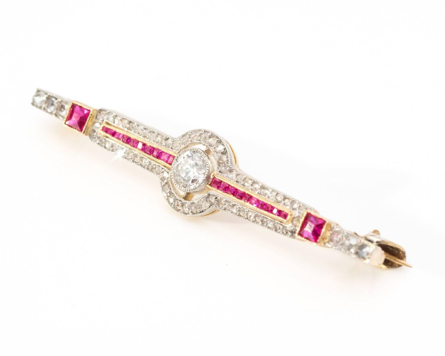 Rare brooch / pin from 1890s, exquisite condition
Crafted in 14 Karat Yellow and White Gold
Features Natural Diamonds and French-Cut Rubies
Center Diamond - old mine cut, 0.25 carat total weight
French Cut Rubies as accent stones
All set in