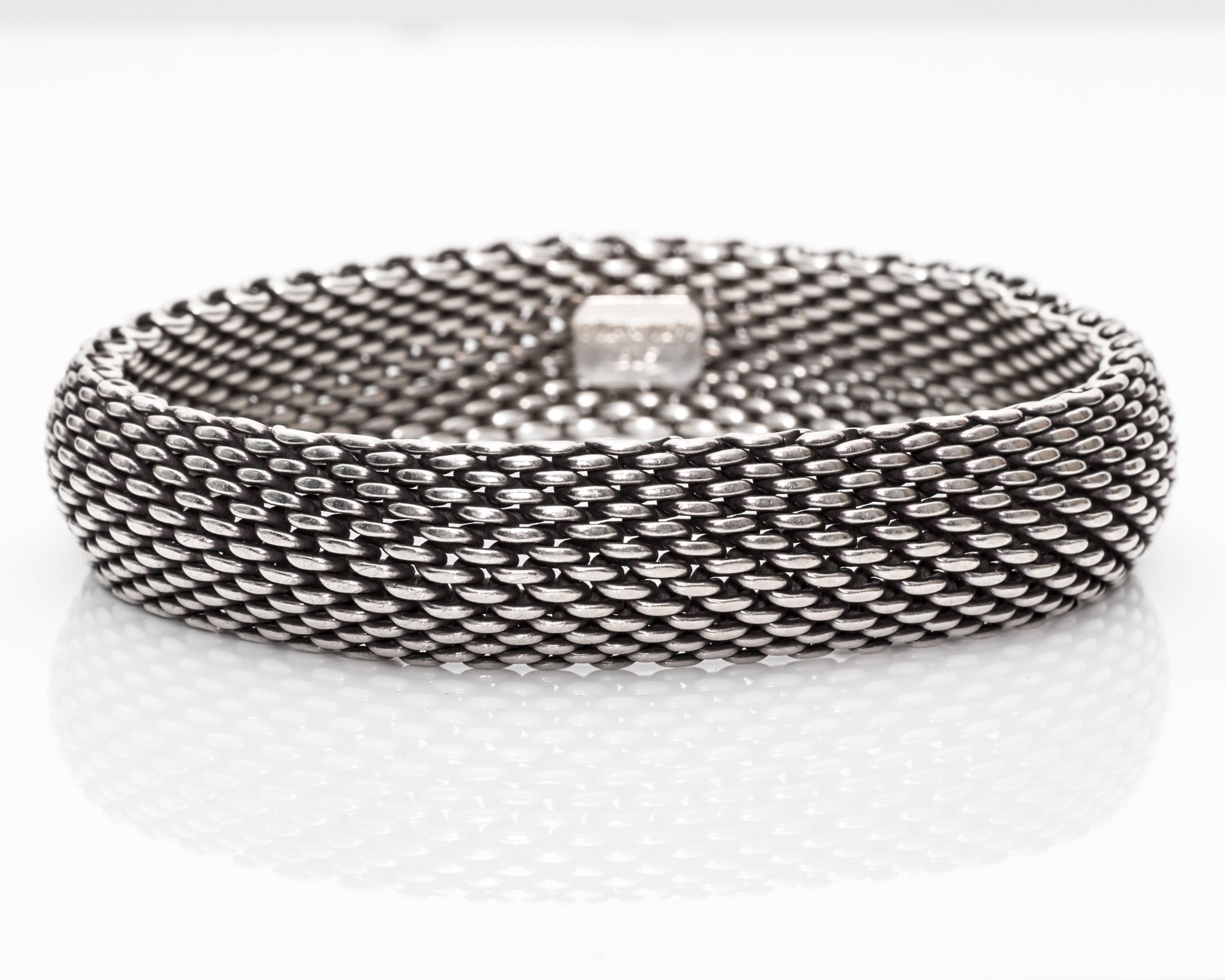 Tiffany & Co. Somerset Bangle/Bracelet 
Wide Style (15 millimeter) Mesh Chain Appearance
Fits 7 Inch Wrist / Large Wrist
One Solid Piece, Slides On & Off
Hallmarked "TIFFANY & CO" and "925" on the Inside
Comes with