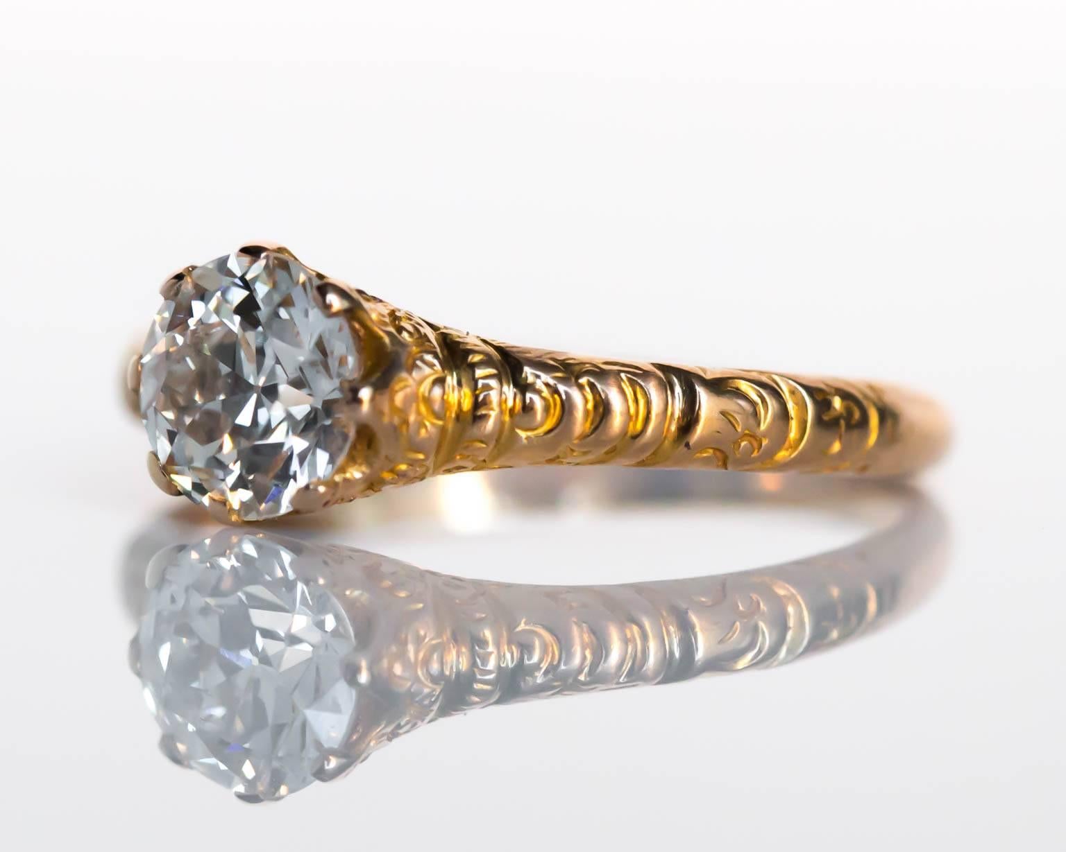 This ring features an intricate carving design around the diamond leading into the shoulders of the shank. 

Item Details: 
Ring Size: 6
Metal Type: 14 Karat Yellow Gold 
Weight: 2.6 grams

Center Diamond Details:
Shape: Old European