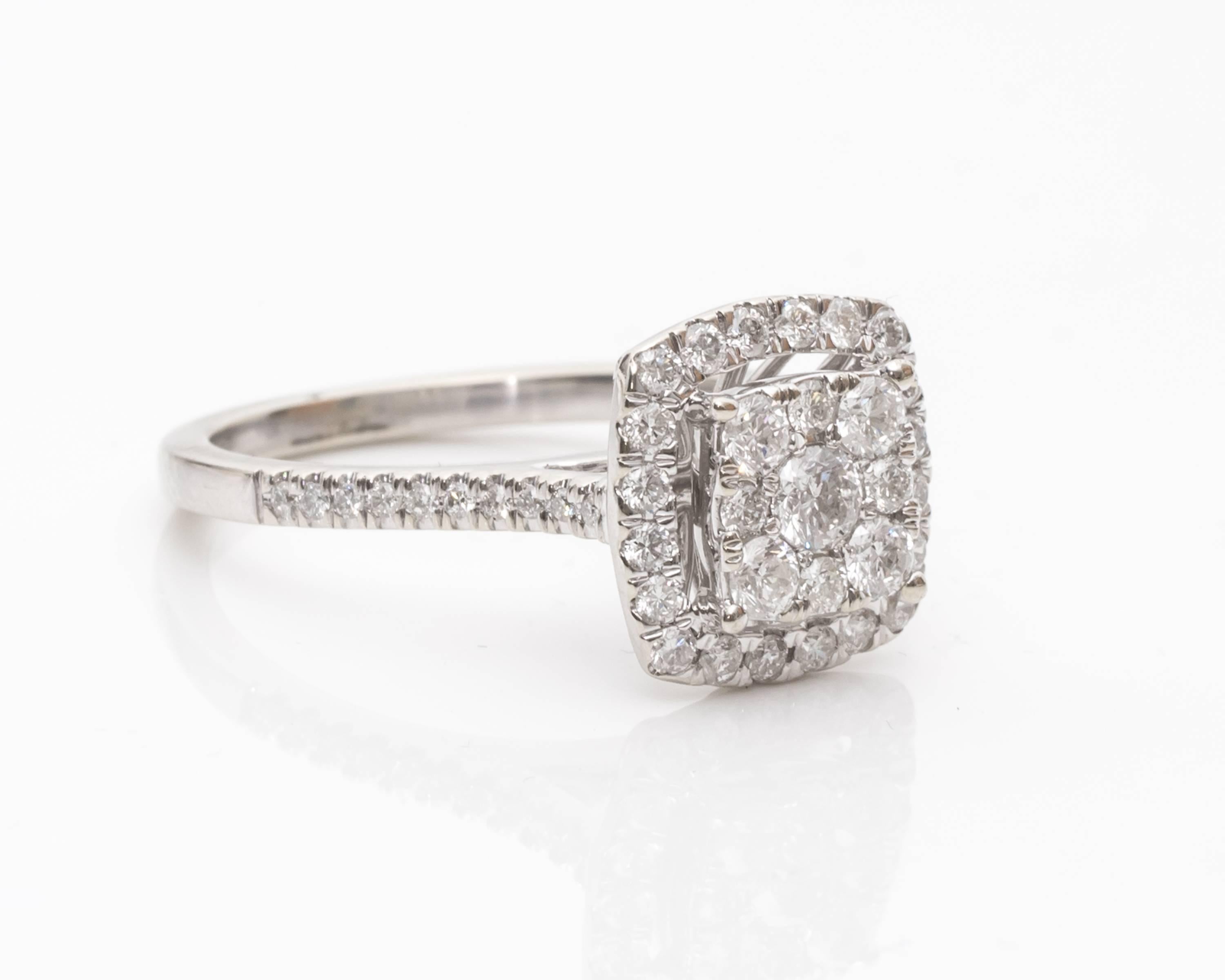 Item Description:
The center of this ring is made up of a cluster of diamonds. From a distance, these stones give the illusion of a large radiant cut stone! There is a halo of additional diamonds lower on the tier of this cathedral ring. Then there