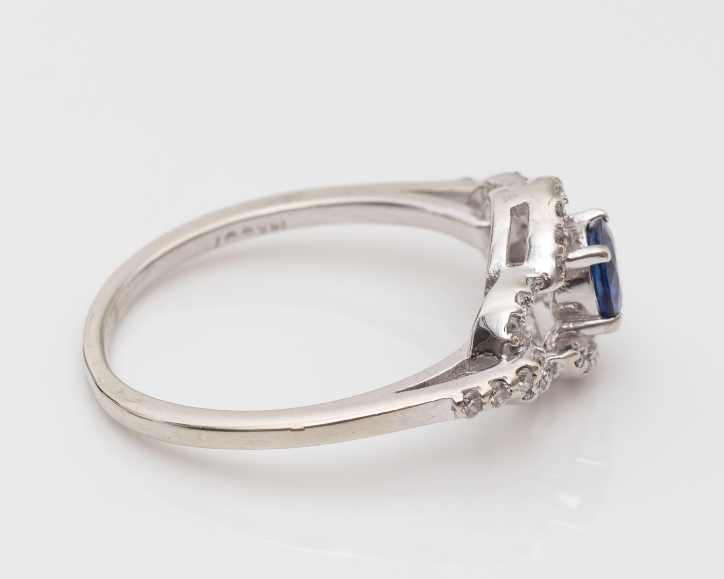 Gorgeous Sapphire and 14 Karat White Gold Diamond Ring
Center Sapphire - vivid blue color, weighing 0.40 carats total, and round cut.
Diamonds - 0.40 carats total offering so much sparkle and shine! 

The sapphire is mounted in a four-prong frame