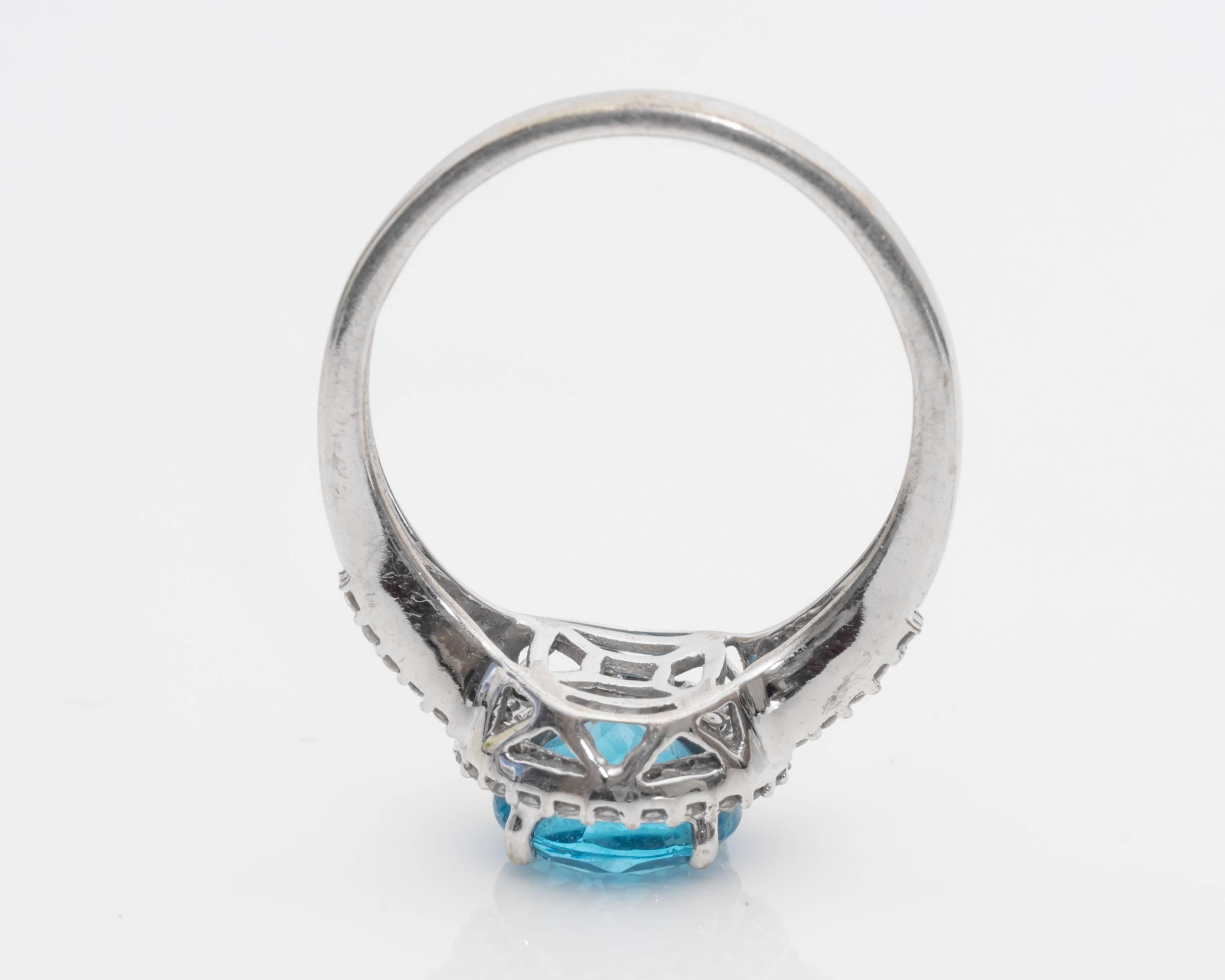 Contemporary 1.0 Carat Blue Topaz and Diamond Halo 14 Karat White Gold Ring