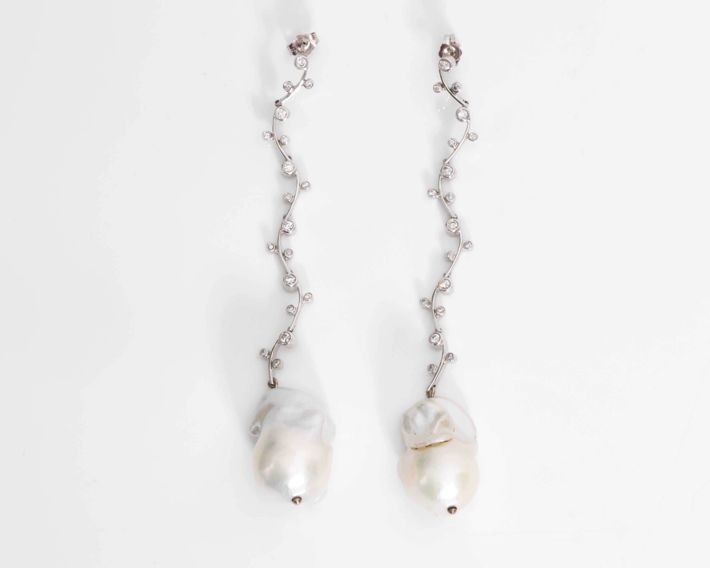 Free-Form Natural Pearl and Diamond Earrings
Dangling Earrings with Flexible Featured Drops
Diamonds are G color, VS clarity, 0.25 carats total 
Push Back Locking Mechanism 
Beautifully Crafted in 14 Karat White Gold with Intricate Floral Vine