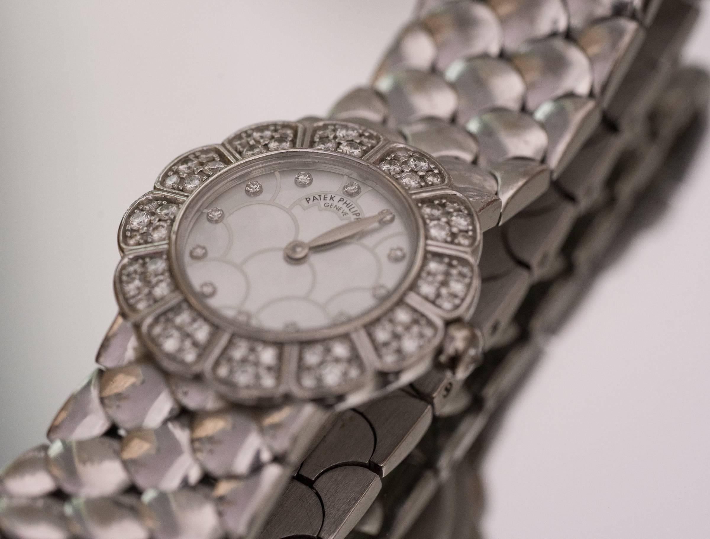 Patek Philipe Crafted in 18 Karat White Gold Women's Wrist Watch
Features a Mother of Pearl Dial
Fits a 7.45 inch wrist
Quartz Movement with a brand new battery
Bracelet resembles a fish-scale pattern, very unique!
Factory Diamond Dial,