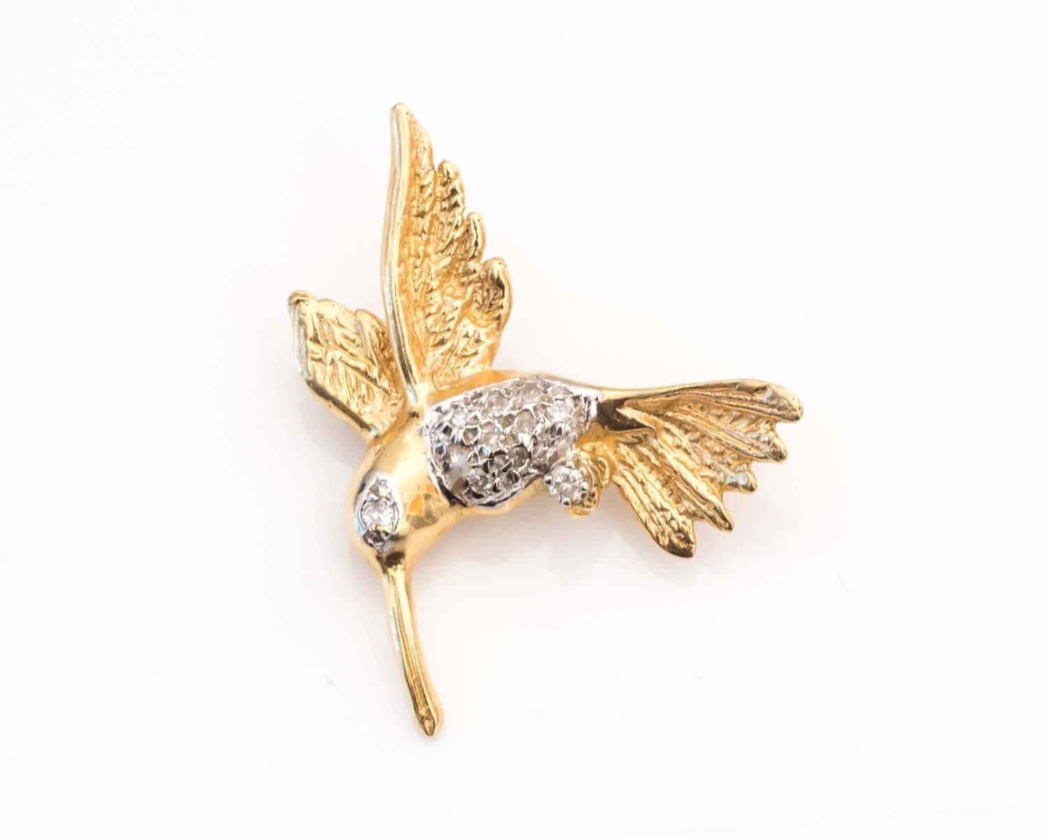 Gorgeous Brooch featuring a Hummingbird Design
Simply Adorable and Elegantly Detailed 
Torso and Eye of the Bird have Diamonds inlayed to the Frame with 14 Karat White Gold
Remainder of the Pin is composed of 14 Karat Yellow Gold for Brilliant Shine