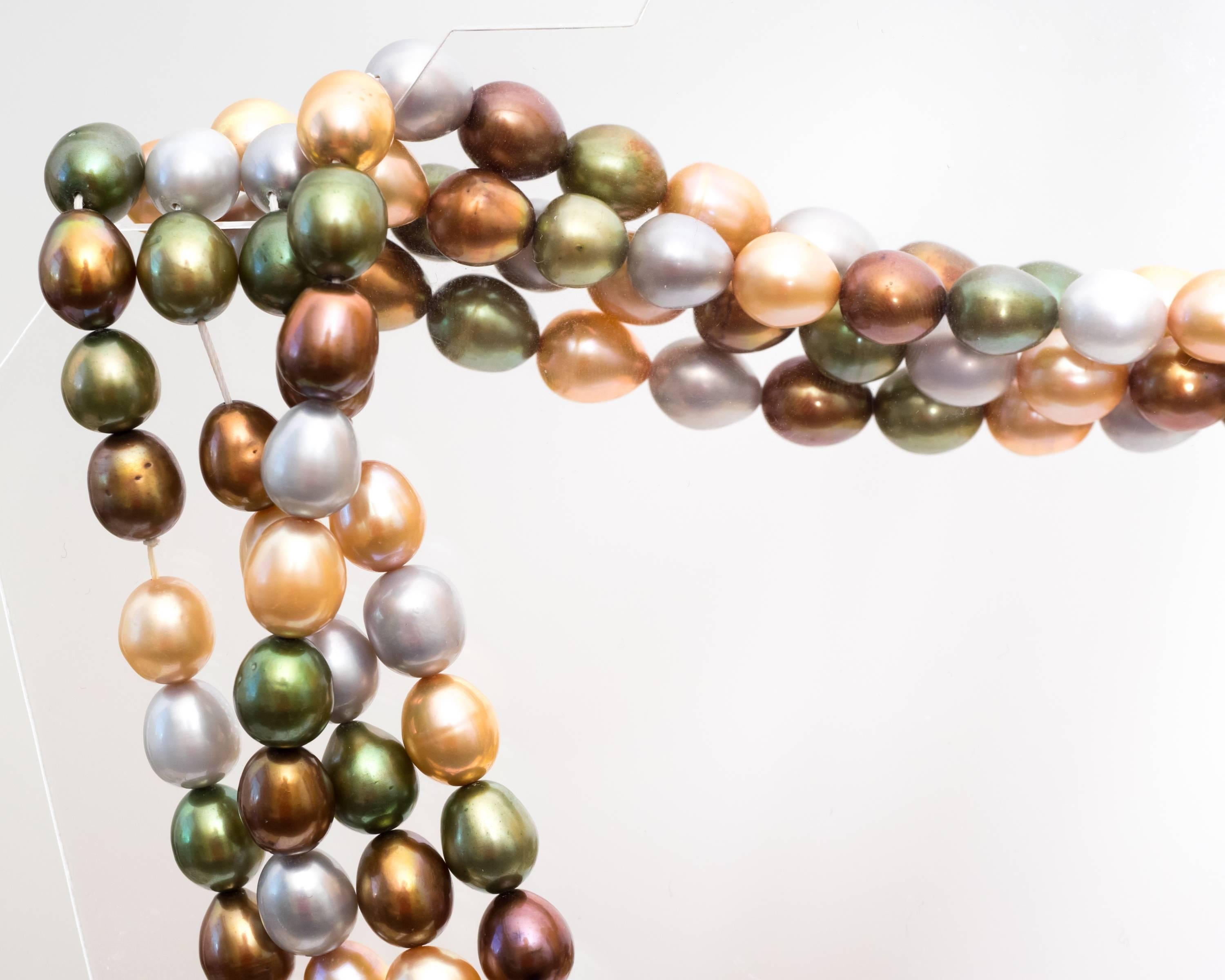 Multicolor Natural South Sea Dyed Pearls
This long seventy two inch strand makes it easy to layer up this necklace. Whether you desire a single long strand, double, or triple layer of lavish pearls. The natural pearls are dyed in olive green, brown,