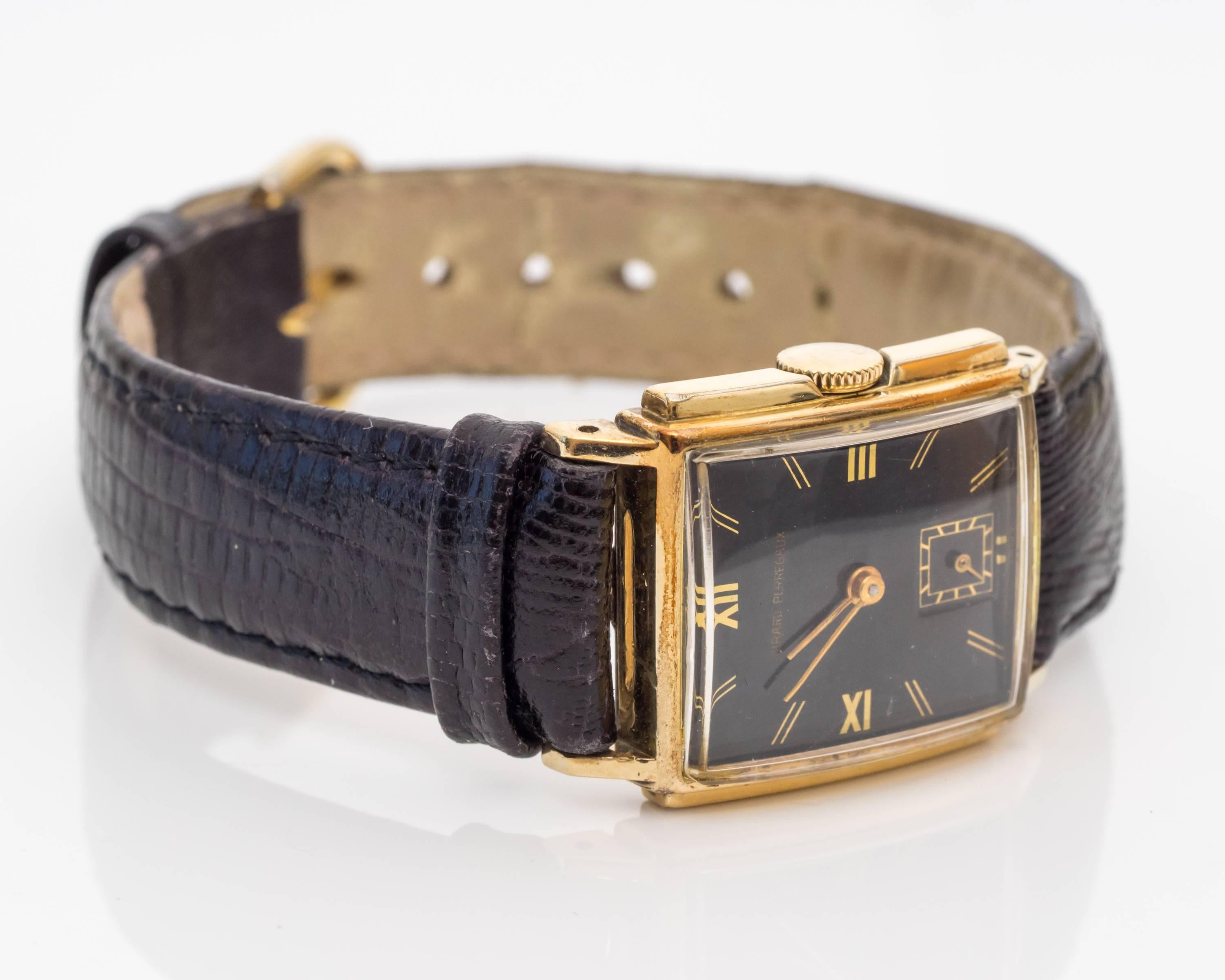 Designer wristwatch, Girard Perregaux 
Simple watch but bold with its roman numeral markers and sleek gold frame
Roman numerals are placed on the "12," "9" and "3" markers. The rest of the numbers are represented by