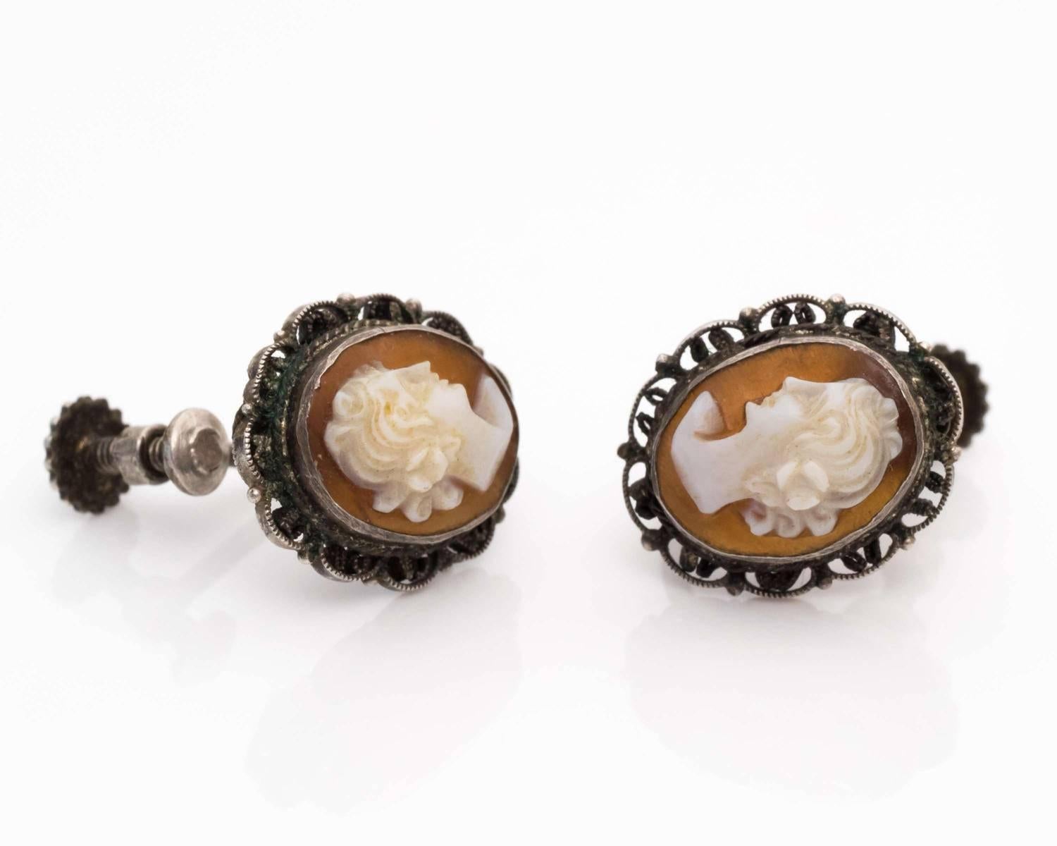 These unique cameo earrings from 1870s are exceptionally beautiful! The intricate hand-carved cameo relief is lovely and elegant. The relief displays a visage of a woman in white with the classic pinkish shell backdrop. The detailed etchings show
