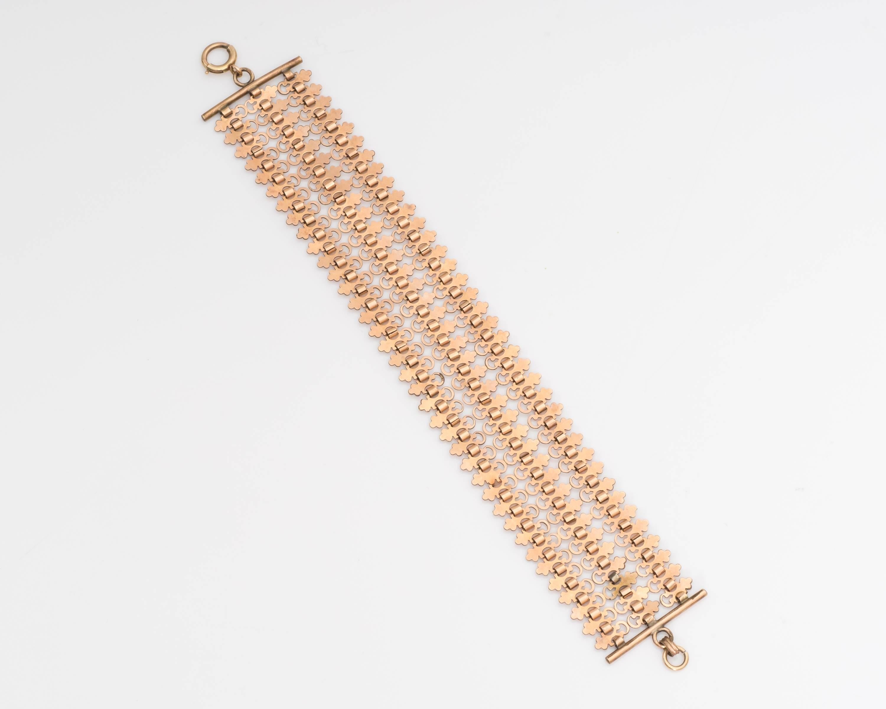 This beautiful bracelet, crafted in 10 karat rose gold, embodies whimsical characteristics. The time and dedication put into this piece is evident through the intricately carved links. The bracelet is connected through tiny chain links with a