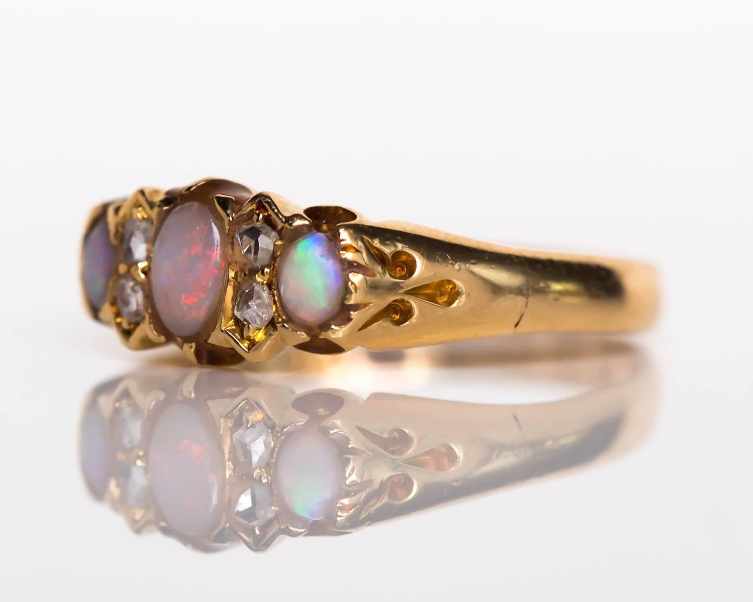 Item Details: 
Ring Size: 6.5
Metal Type: 18 Karat Yellow Gold
Weight: 2.9 grams

Color Stone Details: 
Type: Opal 
Carat Weight: .35 carat, total weight.

Side Stone Details: 
Shape: Antique Rose Cut
Total Carat Weight: .06 carat, total