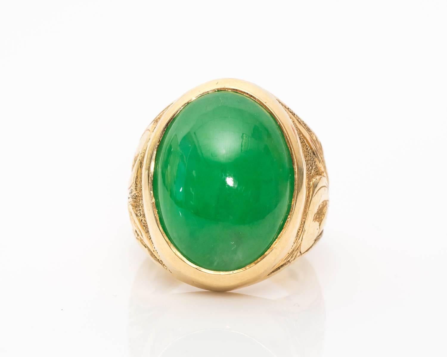 Dramatic yet gorgeous Jade Ring Crafted in 14 Karat Yellow Gold
Features a large oval cabochon Jade
Natural with Minimal Treatments, Beautiful Candy Apple Green Color
Set in Bezel Frame, tapes down to Fanciful Shoulders 
Shoulders on the Ring
