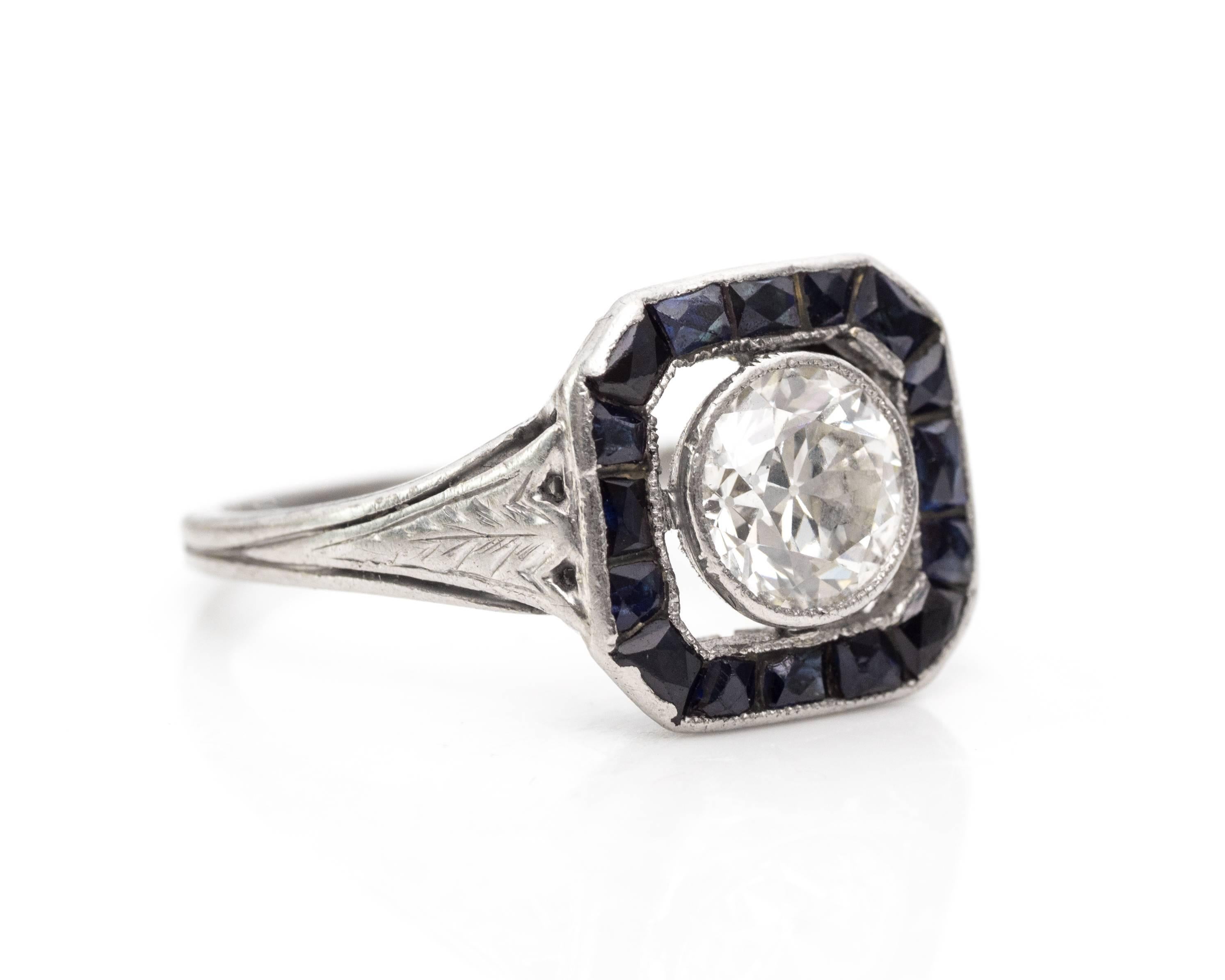 1920s Art Deco .95 Carat Old European Diamond and Sapphire Engagement Ring. Features a Symmetrical Shape and Bold Design!

0.3 carats total French-Cut Sapphires create a beautiful square halo around the center stone. Center features a large 0.95