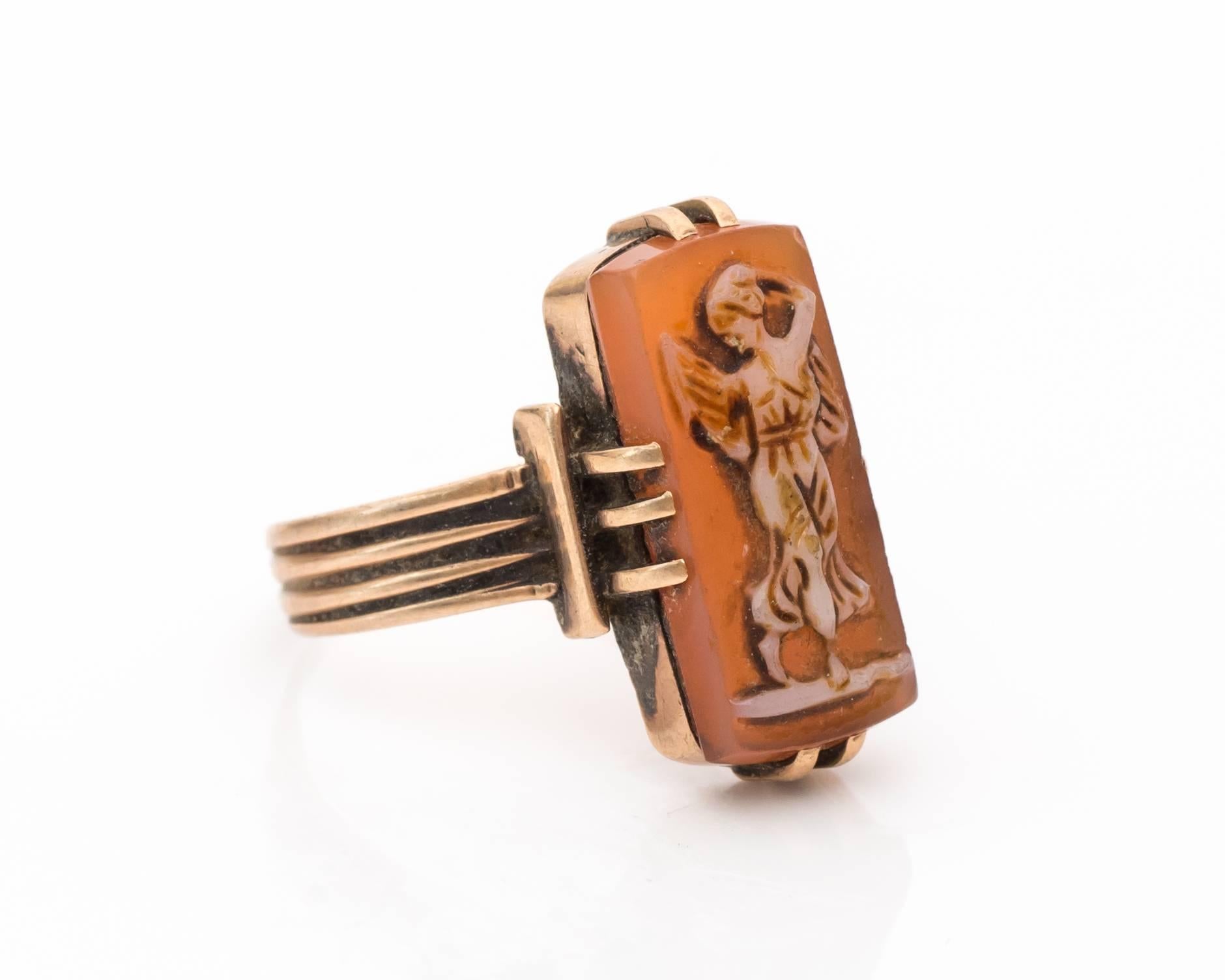 Gorgeous Gold Cameo Ring with Dancing Silhouette
Rectangular cut shell has a cameo relief of a dancing woman. It looks like there are wings behind her back, so it might also be an angel motif. The woman has cream and brown colors along the frame,